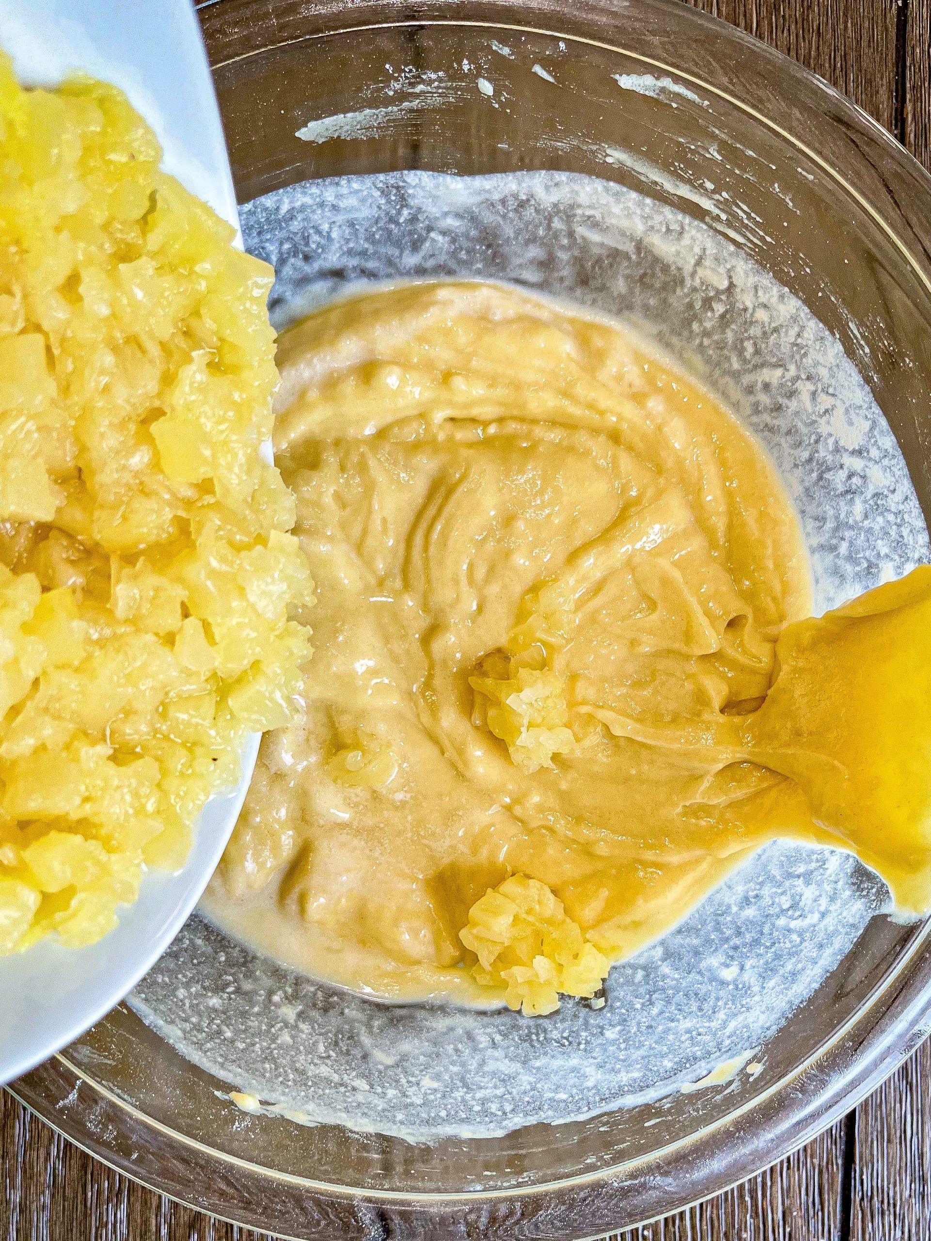 Fold the crushed pineapple into the mixture.