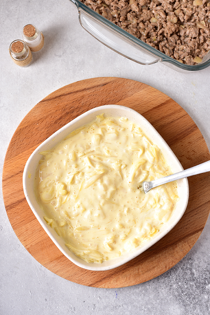 Whisk together the eggs, 1 cup of cheese, and the heavy whipping cream.