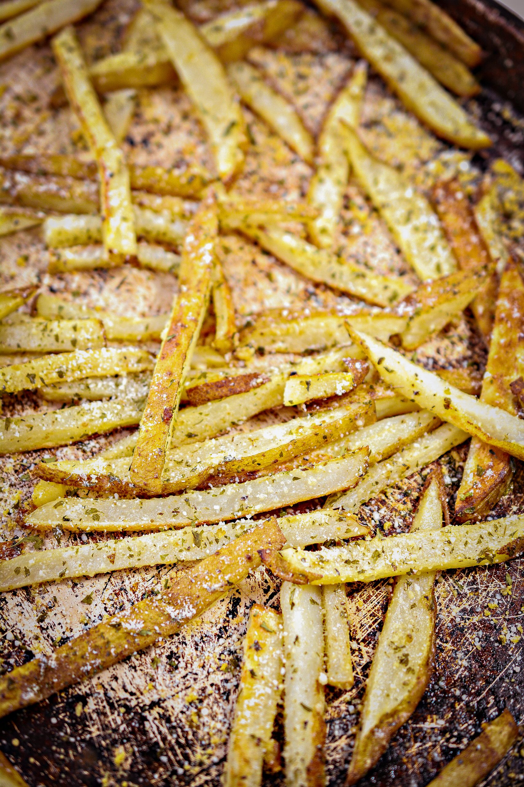 Sprinkle the fries with the parsley flakes and ¼ cup of Parmesan, and toss to coat.