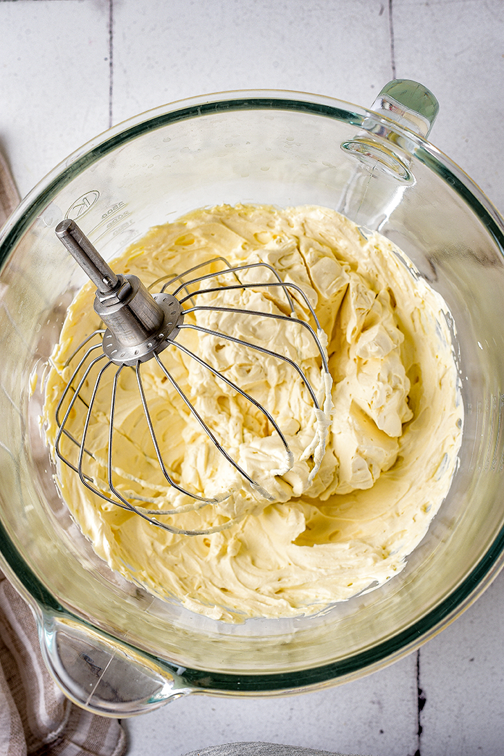 In a mixing bowl, blend together the heavy whipping cream and sugar until soft peaks have formed. Set aside.