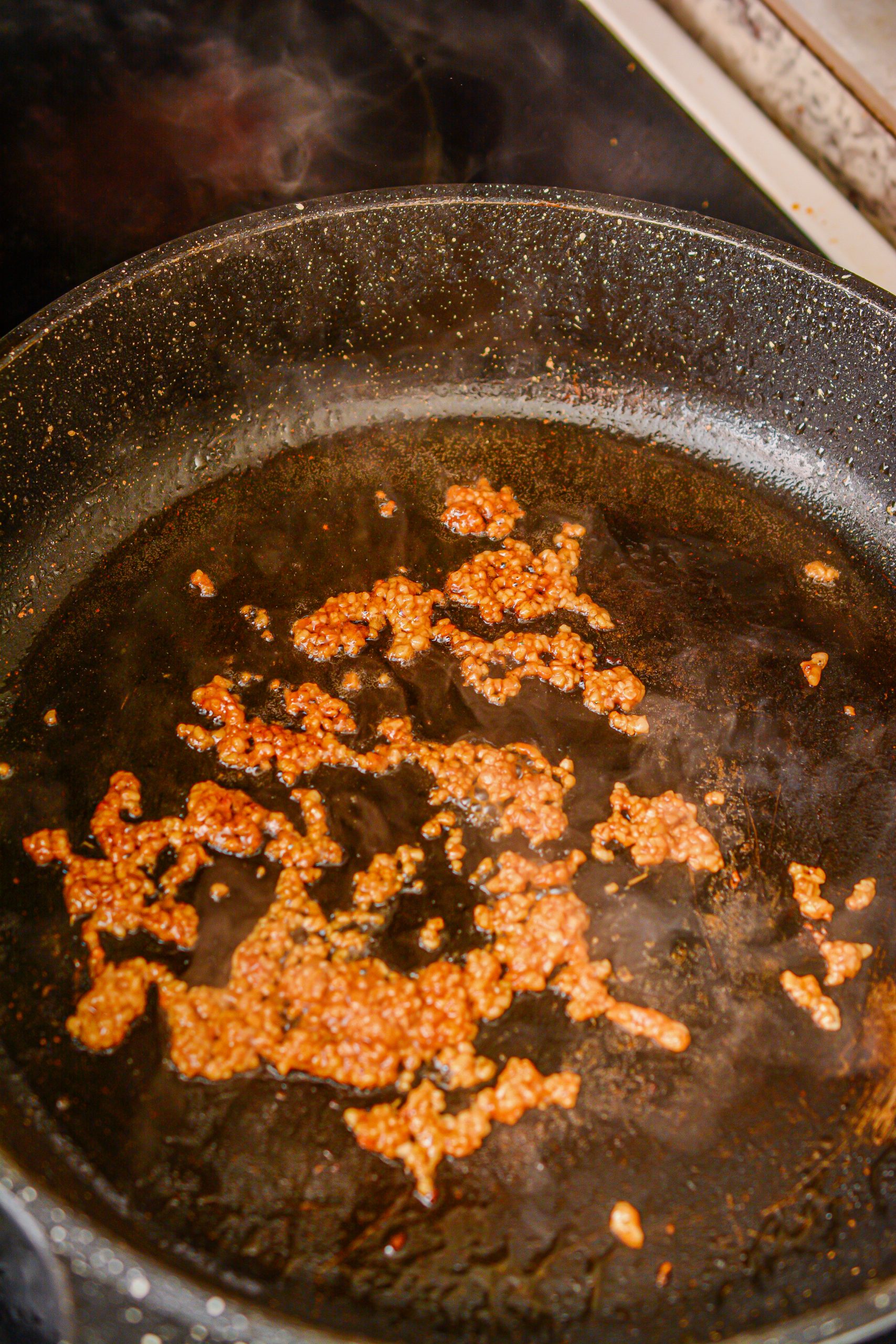 In the same skillet over medium heat, add the garlic to the remaining oil.