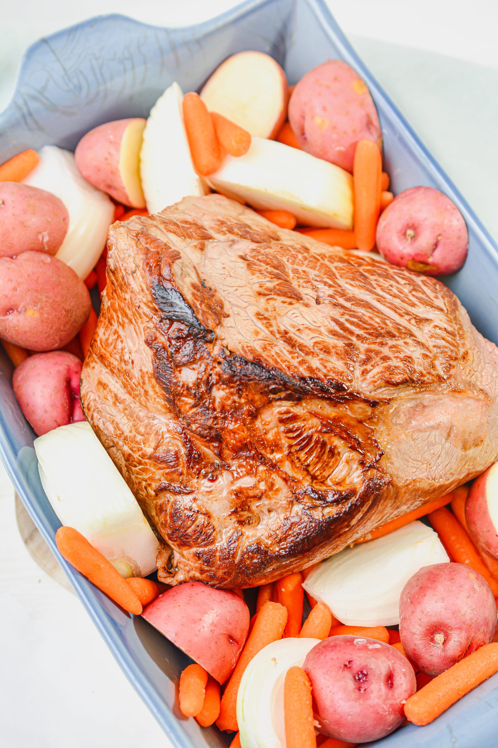 Surround the roast with the vegetables.