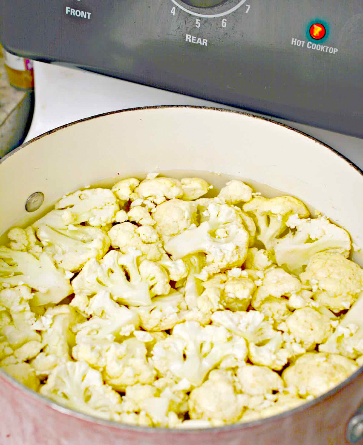 Bring the cauliflower in water to a boil over medium-high heat on the stove.