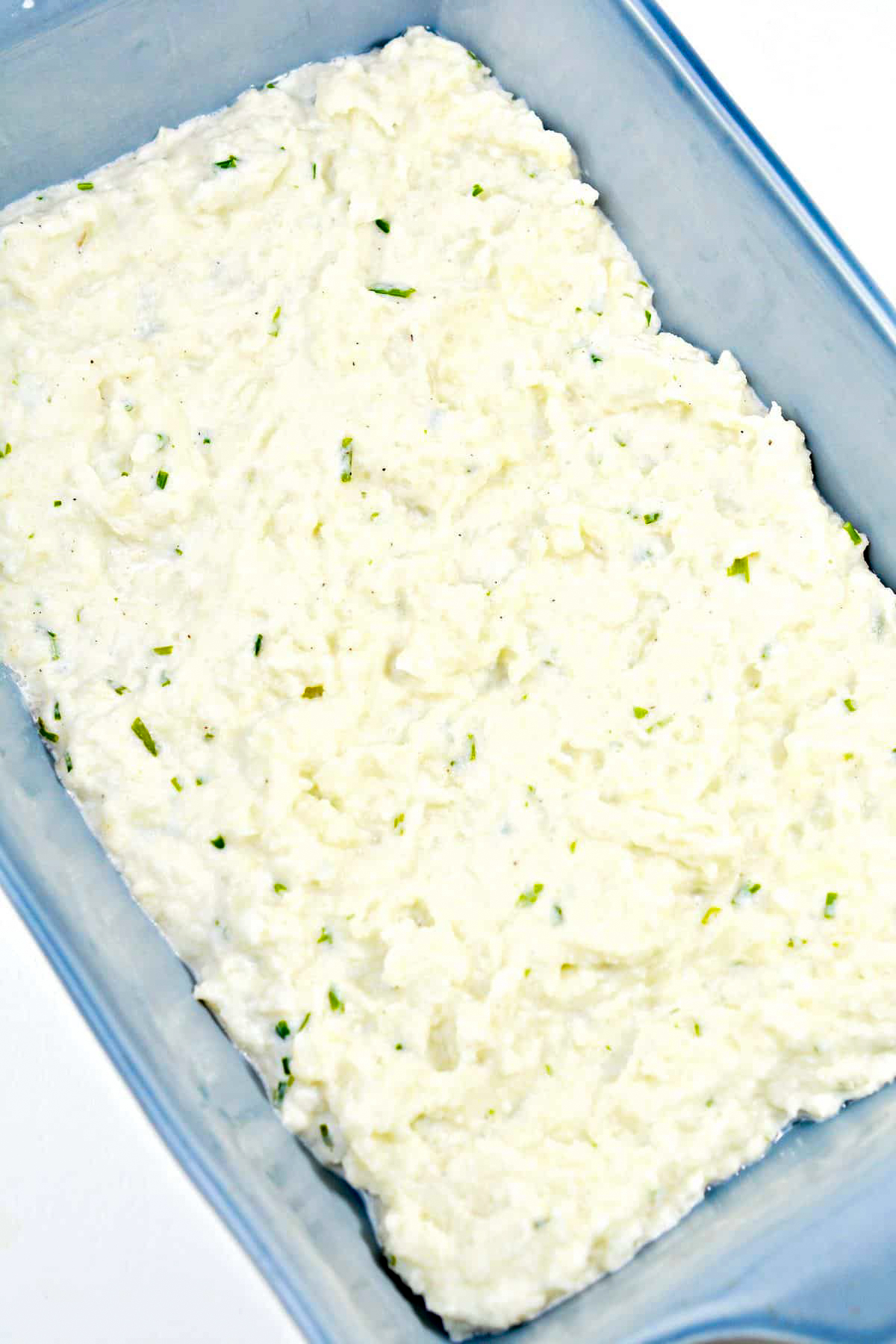Place the cauliflower mixture in an even layer at the bottom of a well-greased baking dish.