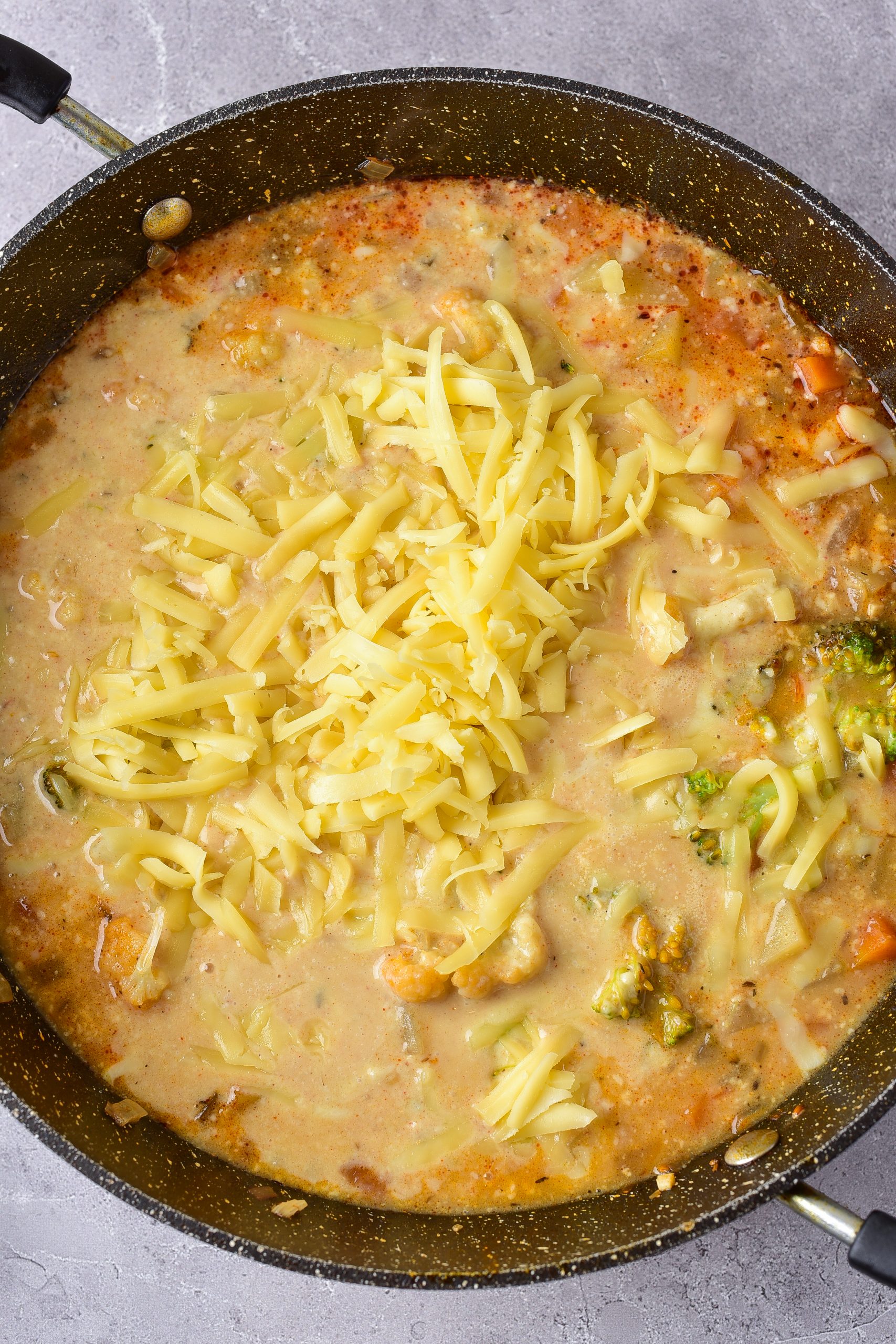 Sprinkle in the cheese, and stir until the cheese has melted before serving. 