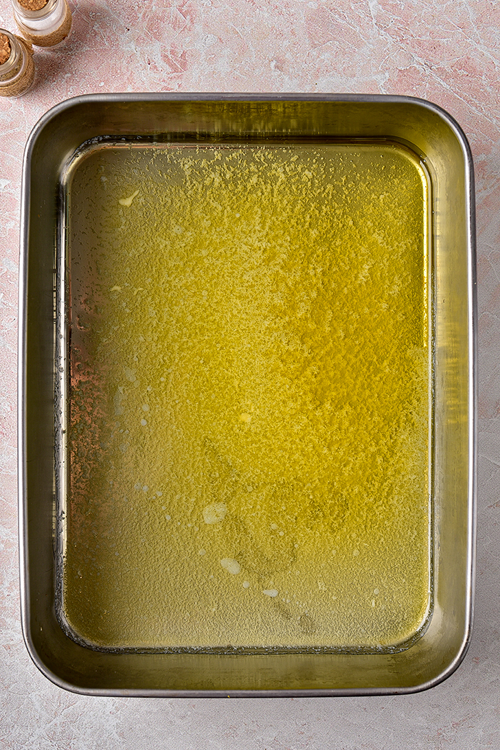 Melt the butter, then place it into the bottom of a 9x13 baking dish.