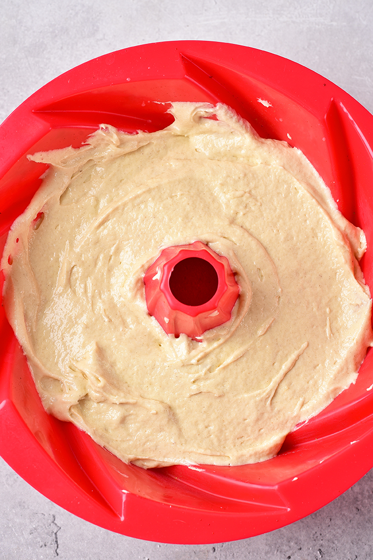 Spread half of the batter over the peaches in the bundt pan. 
