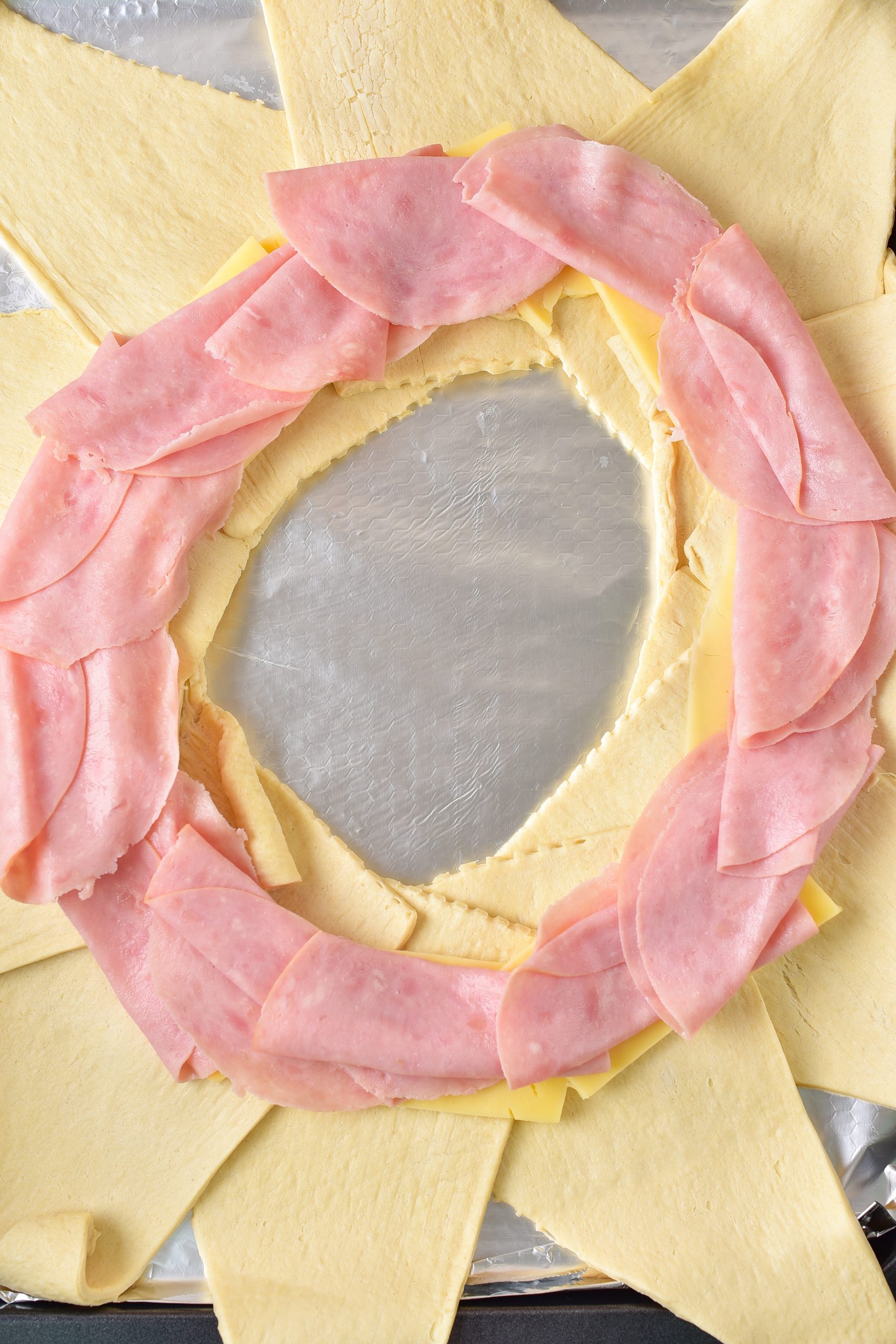Top the cheese with the salami.