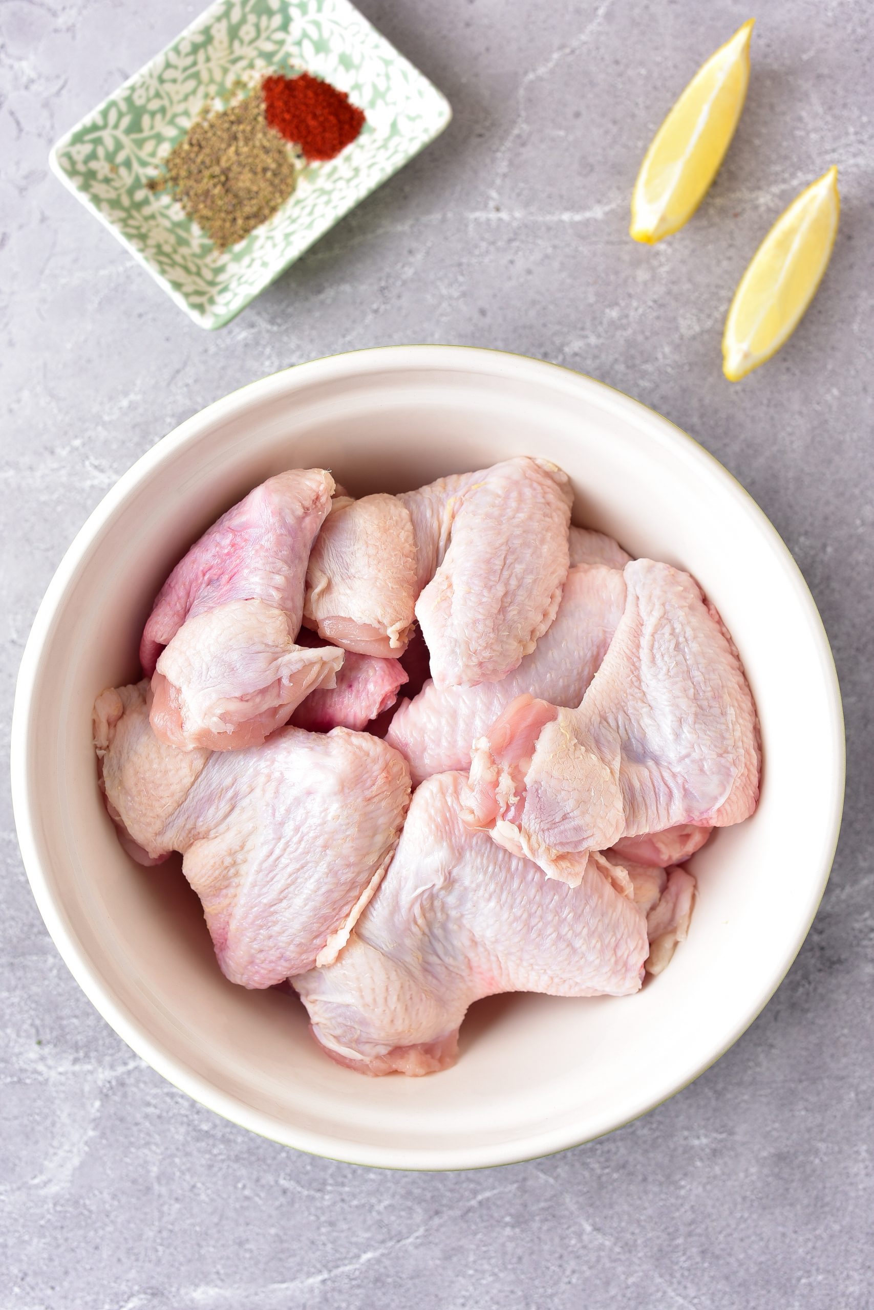 Place the chicken wings in a large mixing bowl.