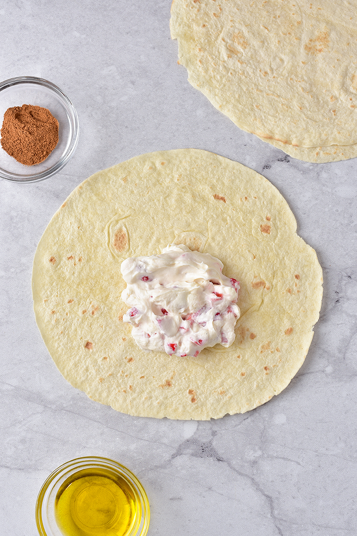 Divide the cream cheese mixture into six servings, and layer on the bottom ⅓ of each tortilla.