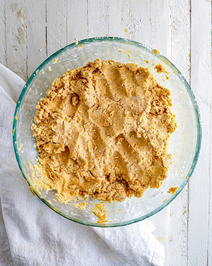 In a medium bowl, mix peanut butter, butter, vanilla, and confectioners’ sugar with your hands to form a smooth stiff dough