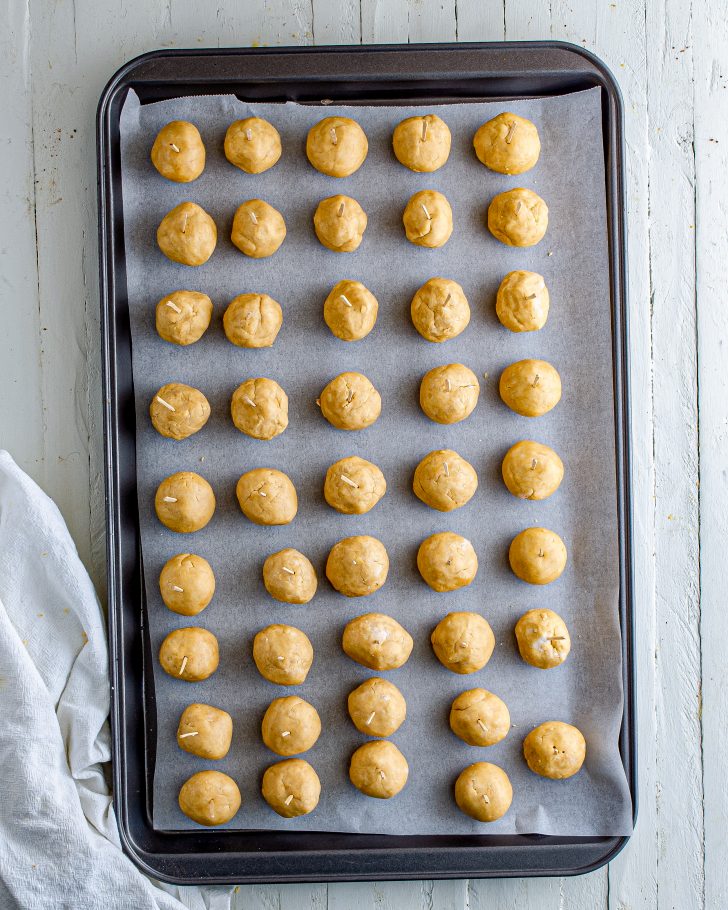 Shape into balls using 2 teaspoons of dough for each ball and insert a wooden toothpick into the ball. Place on prepared pan, and refrigerate for at least 1 hour