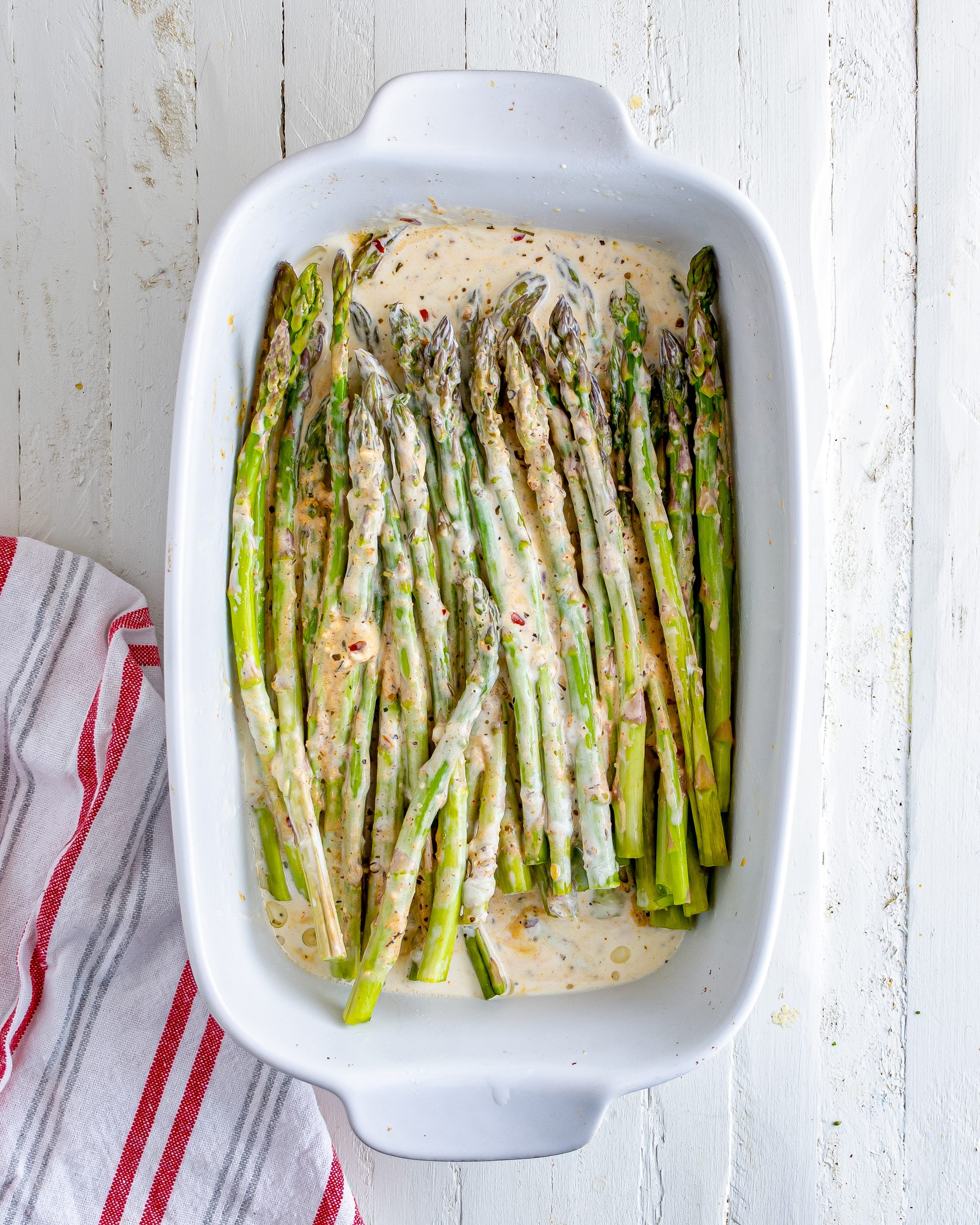 Layer the asparagus in a well-greased 9x13 baking dish, and top with the sauce. 