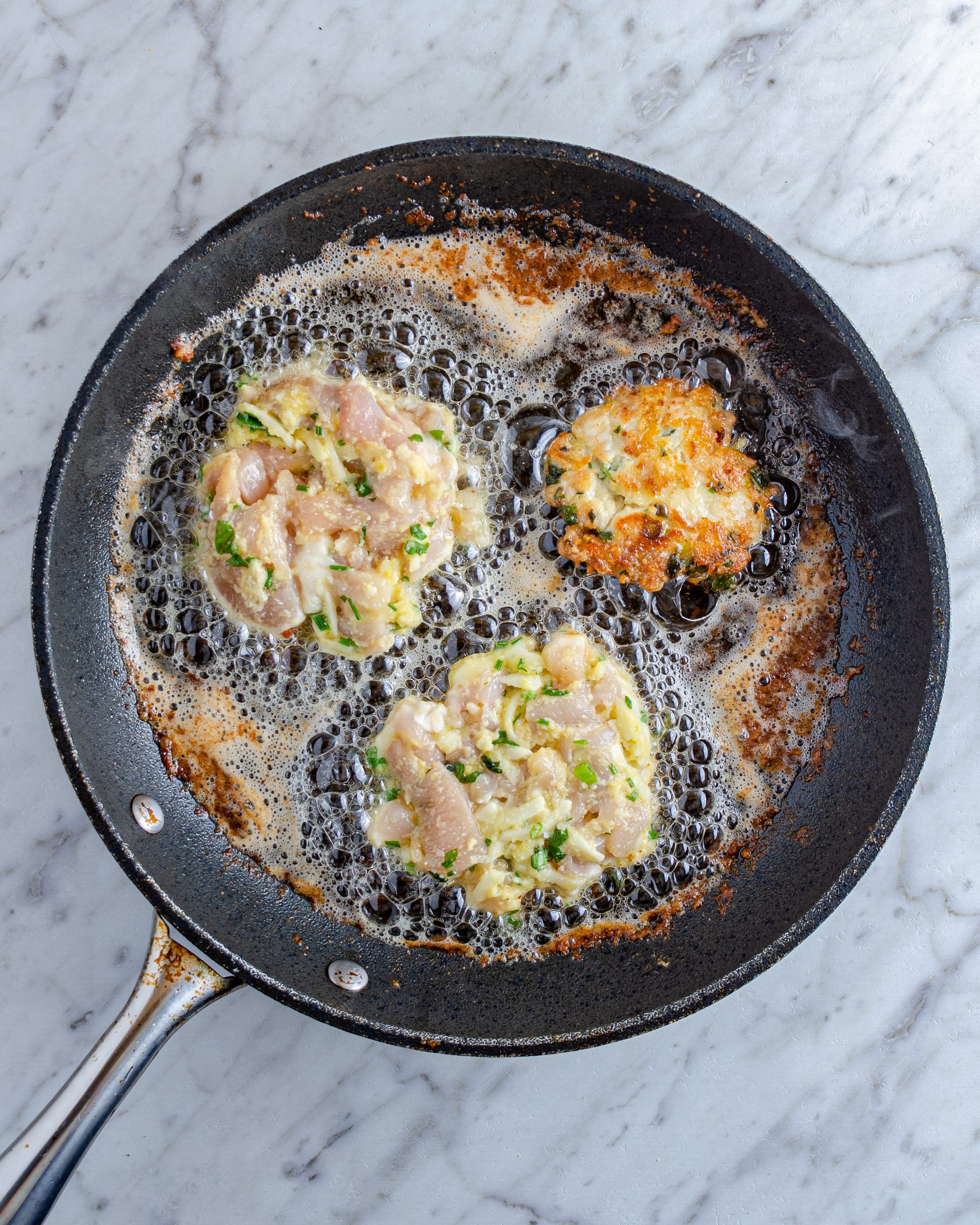 Drop spoonfuls of the chicken mixture into the skillet, and flatten slightly with a spatula. Fry evenly on both sides until golden brown, and until the chicken is cooked through