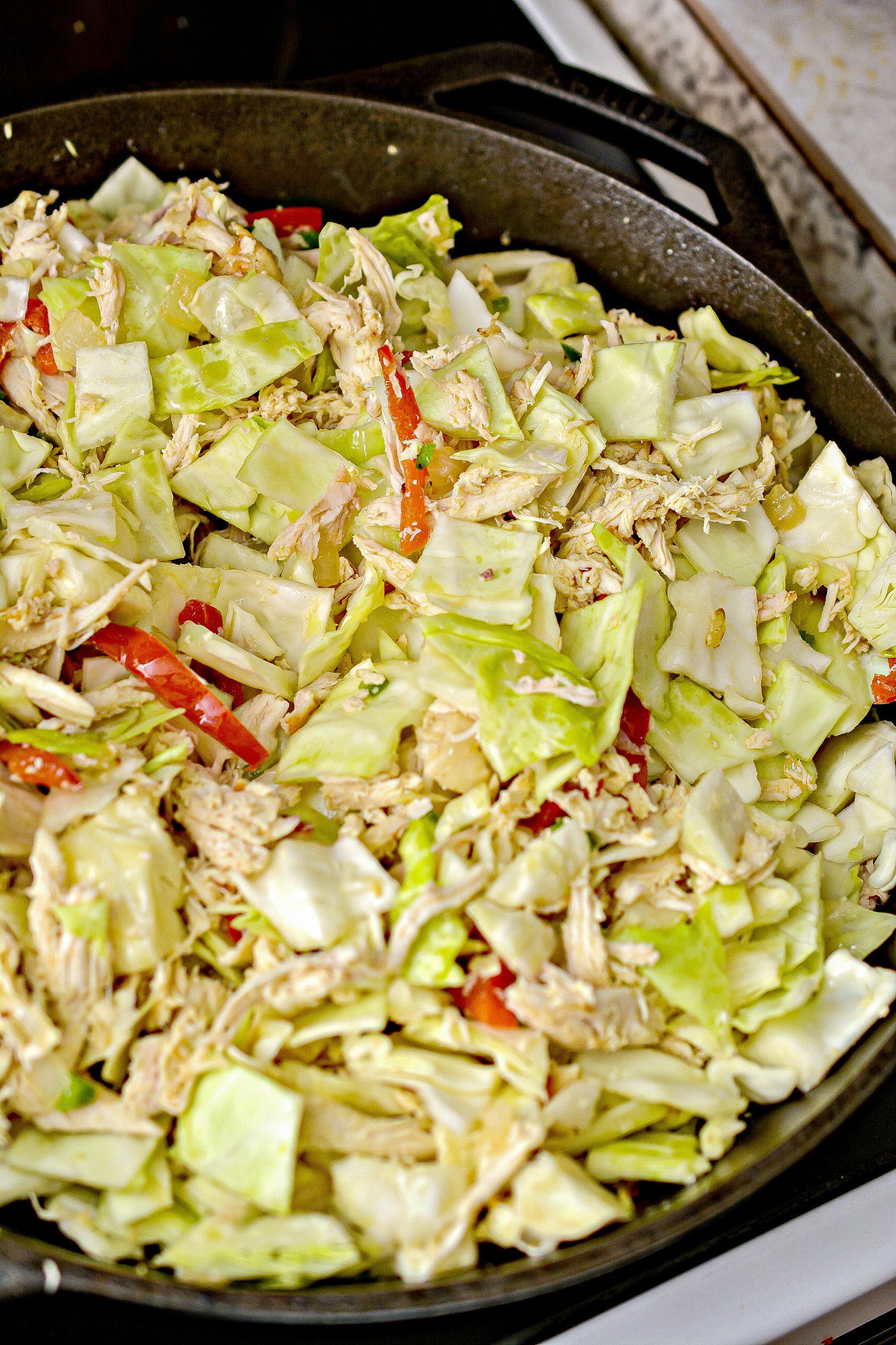 Add the chicken and cabbage to the skillet, tossing to mix well