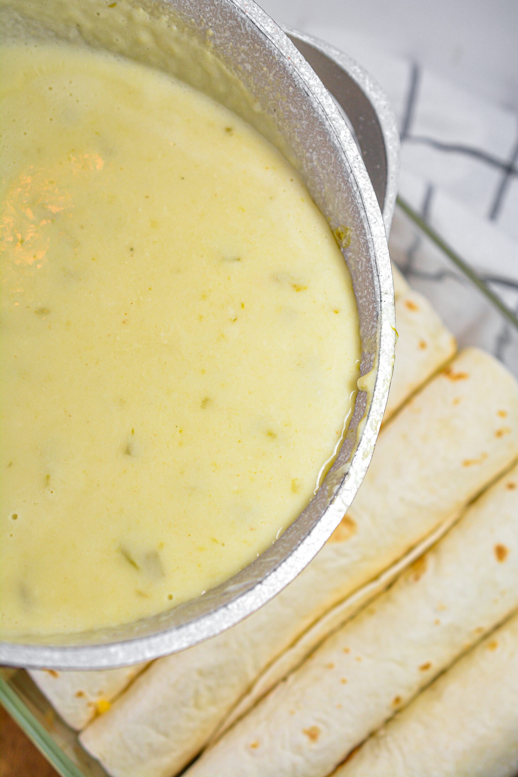 Pour the sauce over the tortillas.