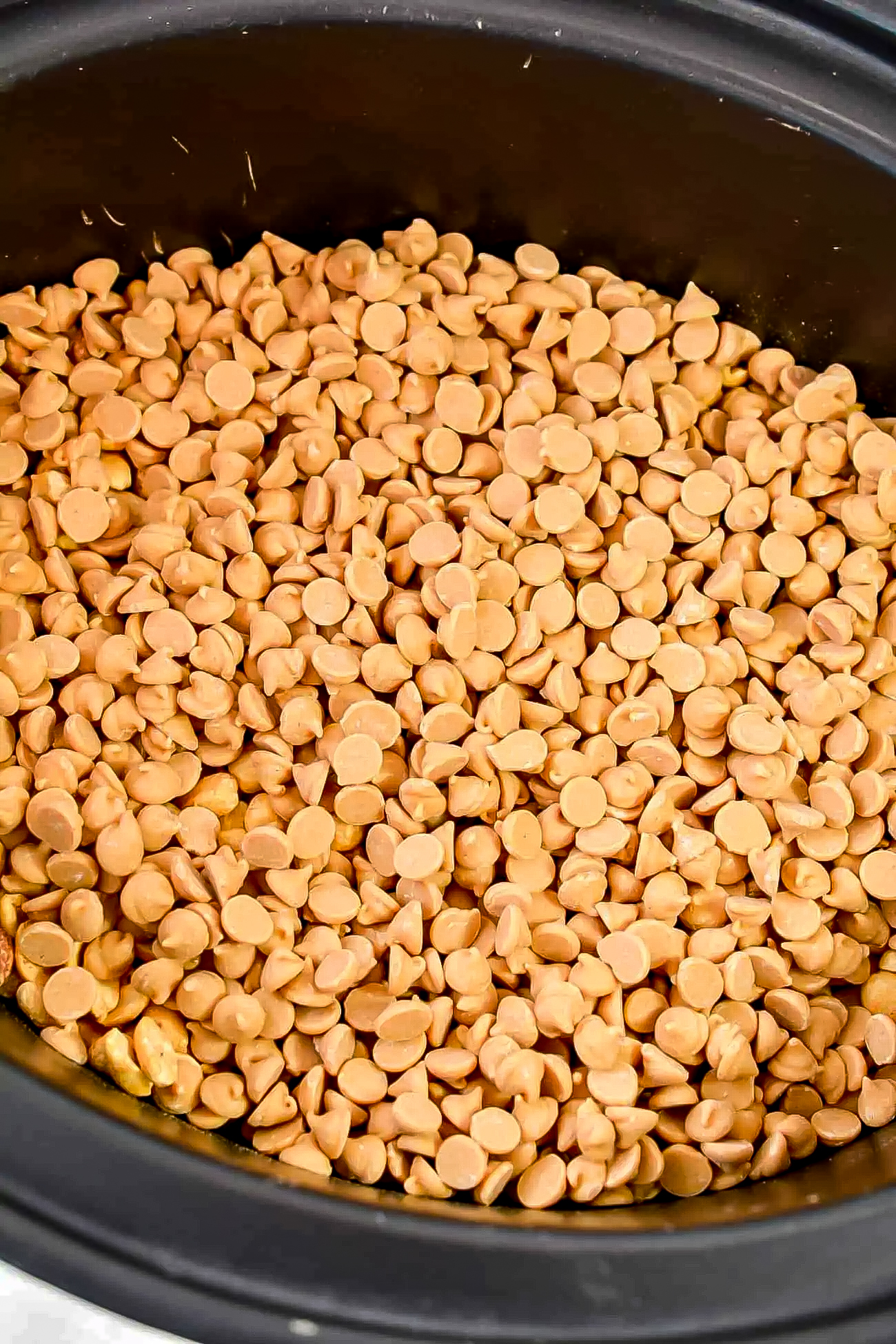 Cover the peanuts with peanut butter chips.