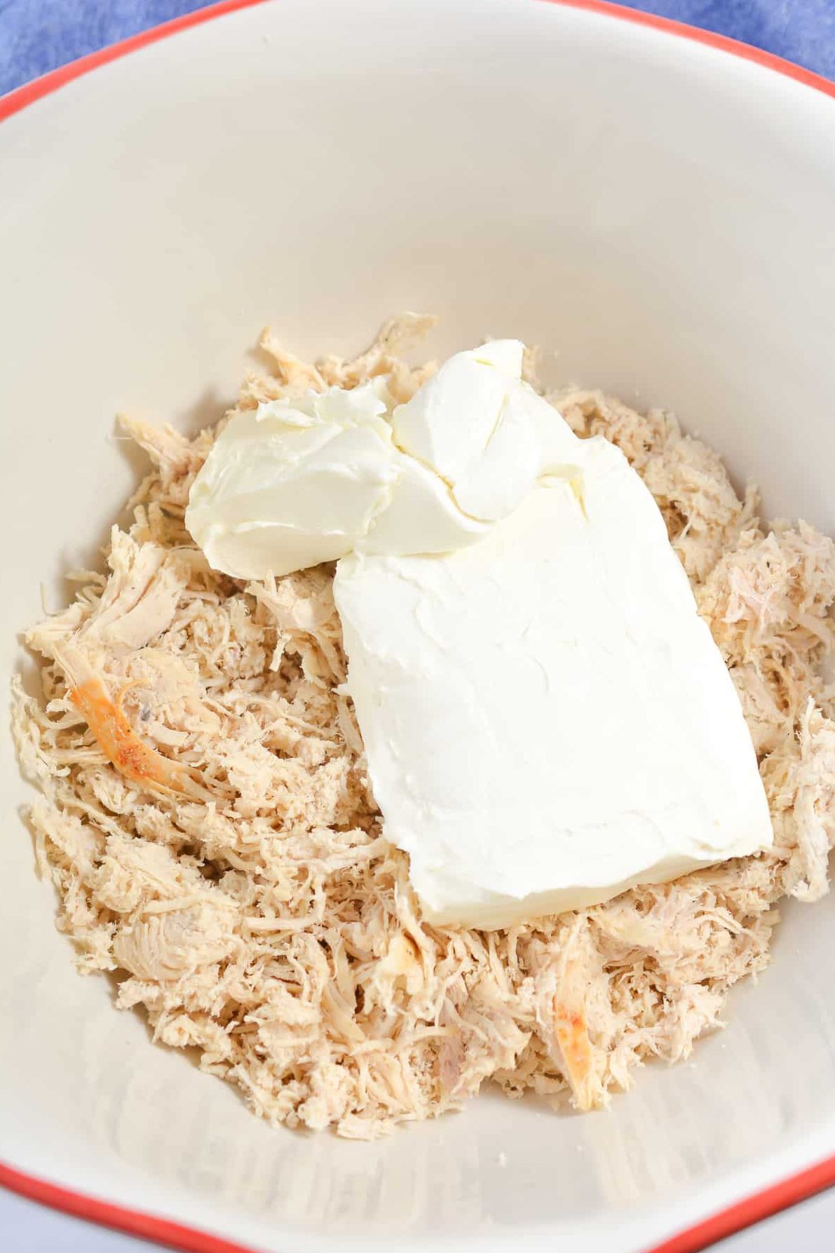 In a large mixing bowl, combine the chicken and cream cheese.