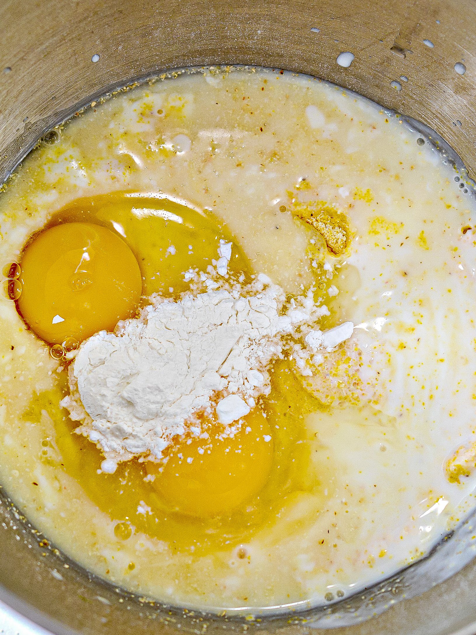 Adding large eggs, baking powder, and salt.