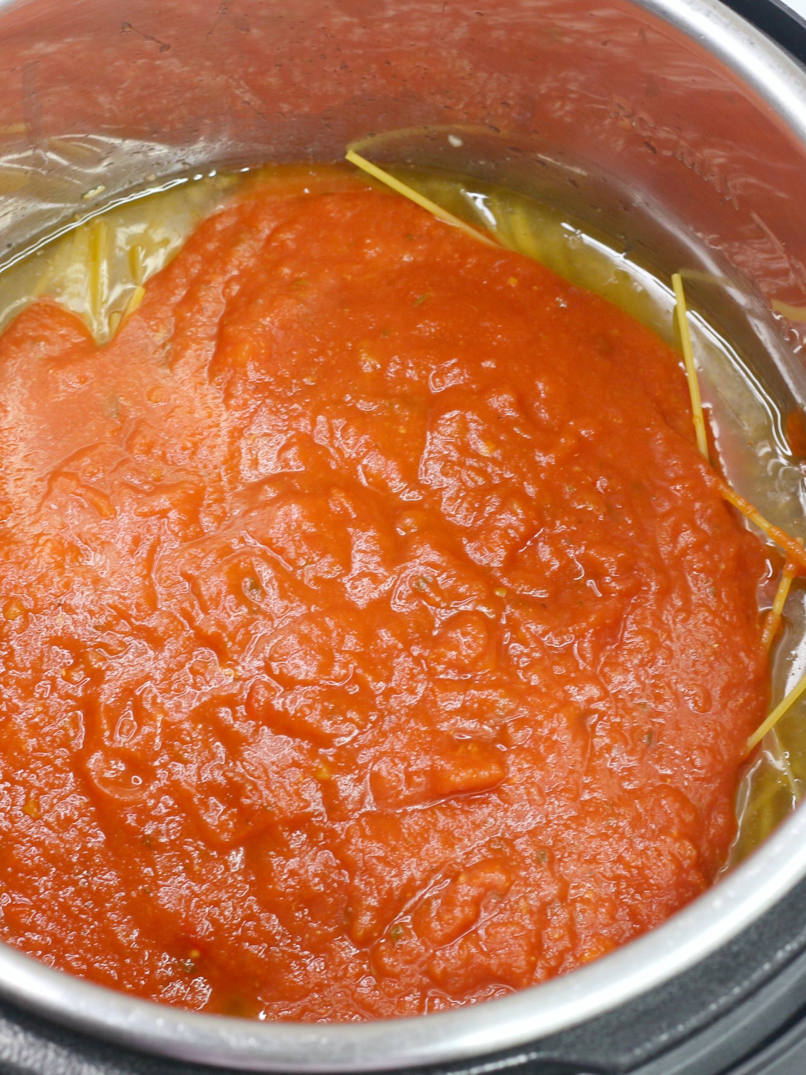 Pour diced tomatoes over the sauce.