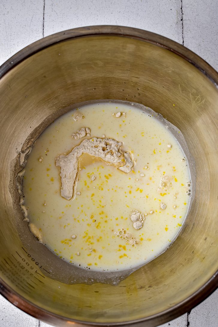 In a large bowl, mix together flour, sugar, milk, vanilla, and lemon peel until fully combined