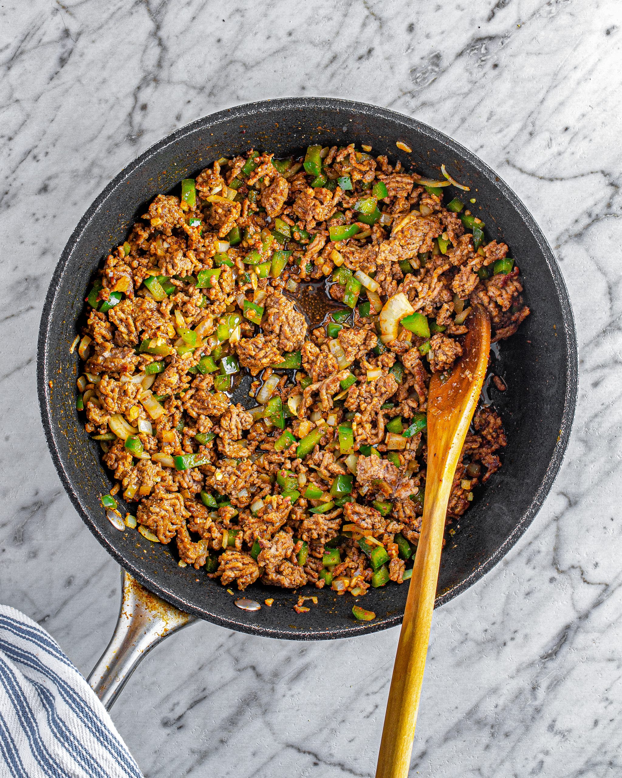 Reduce the heat to medium, and stir in the garlic, chili powder, ground mustard, salt, and pepper.