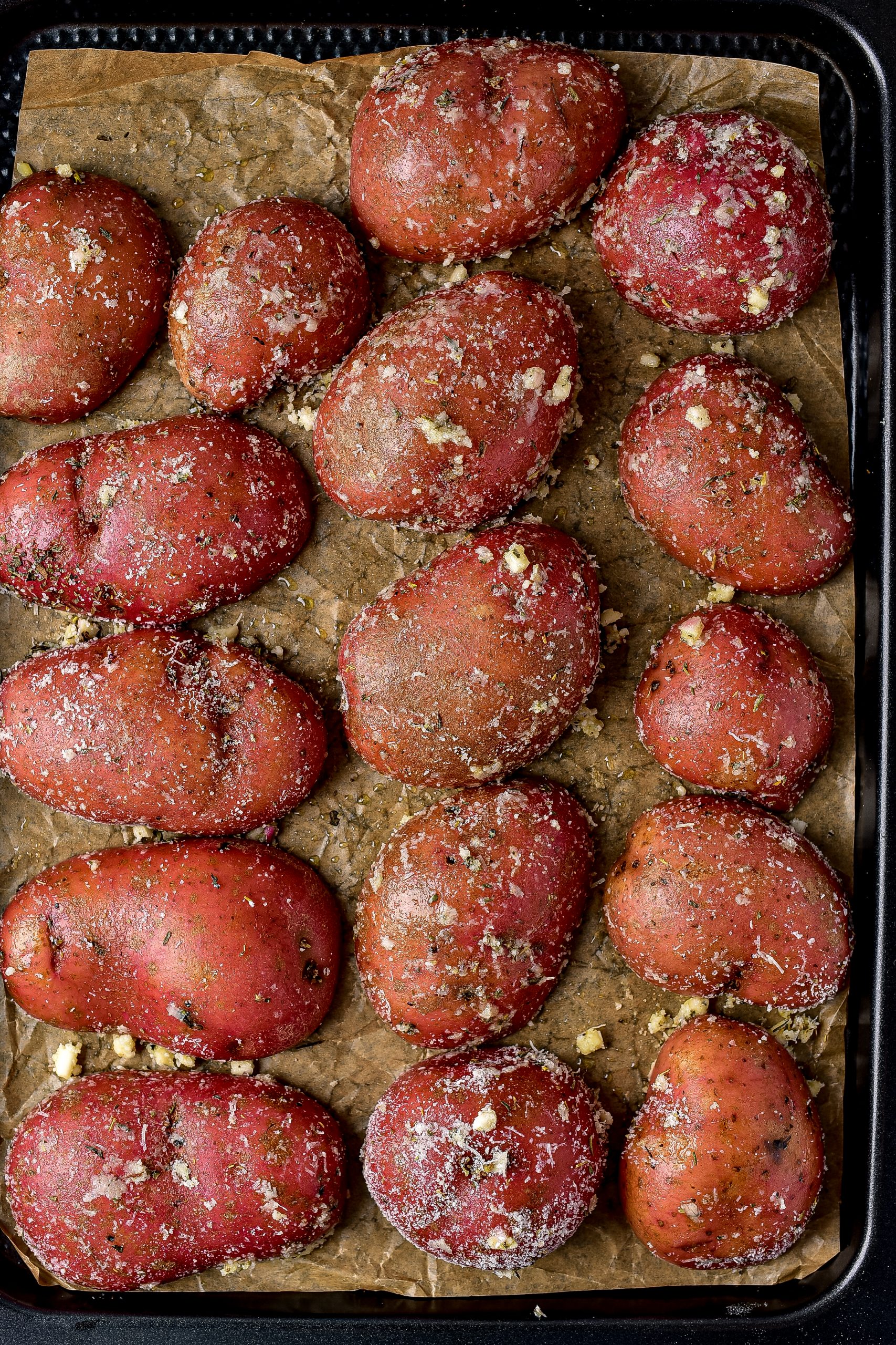 arrange the potatoes on the baking sheet in an even layer. Place the potatoes peel side up.