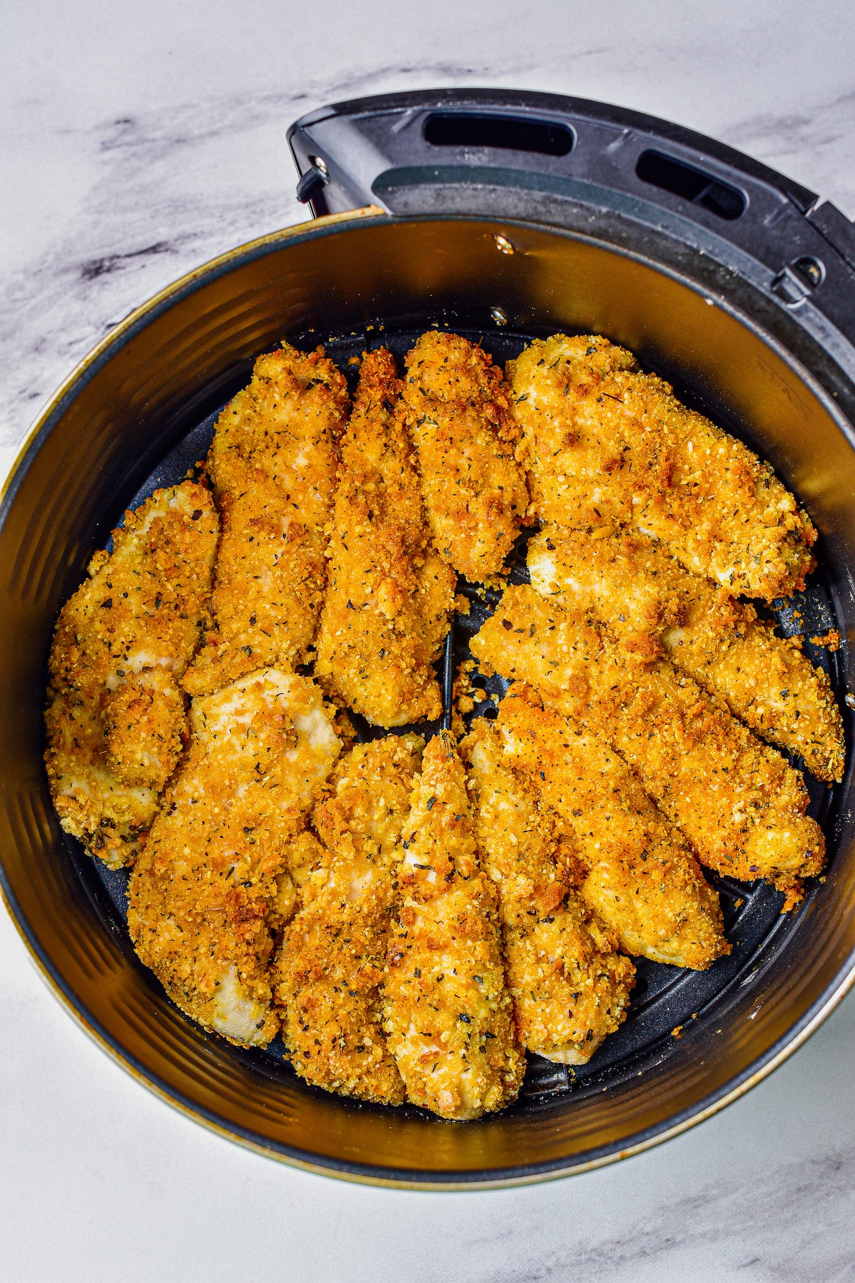Place the chicken into a basket for the air fryer, and cook for 9-10 minutes at 400 degrees.