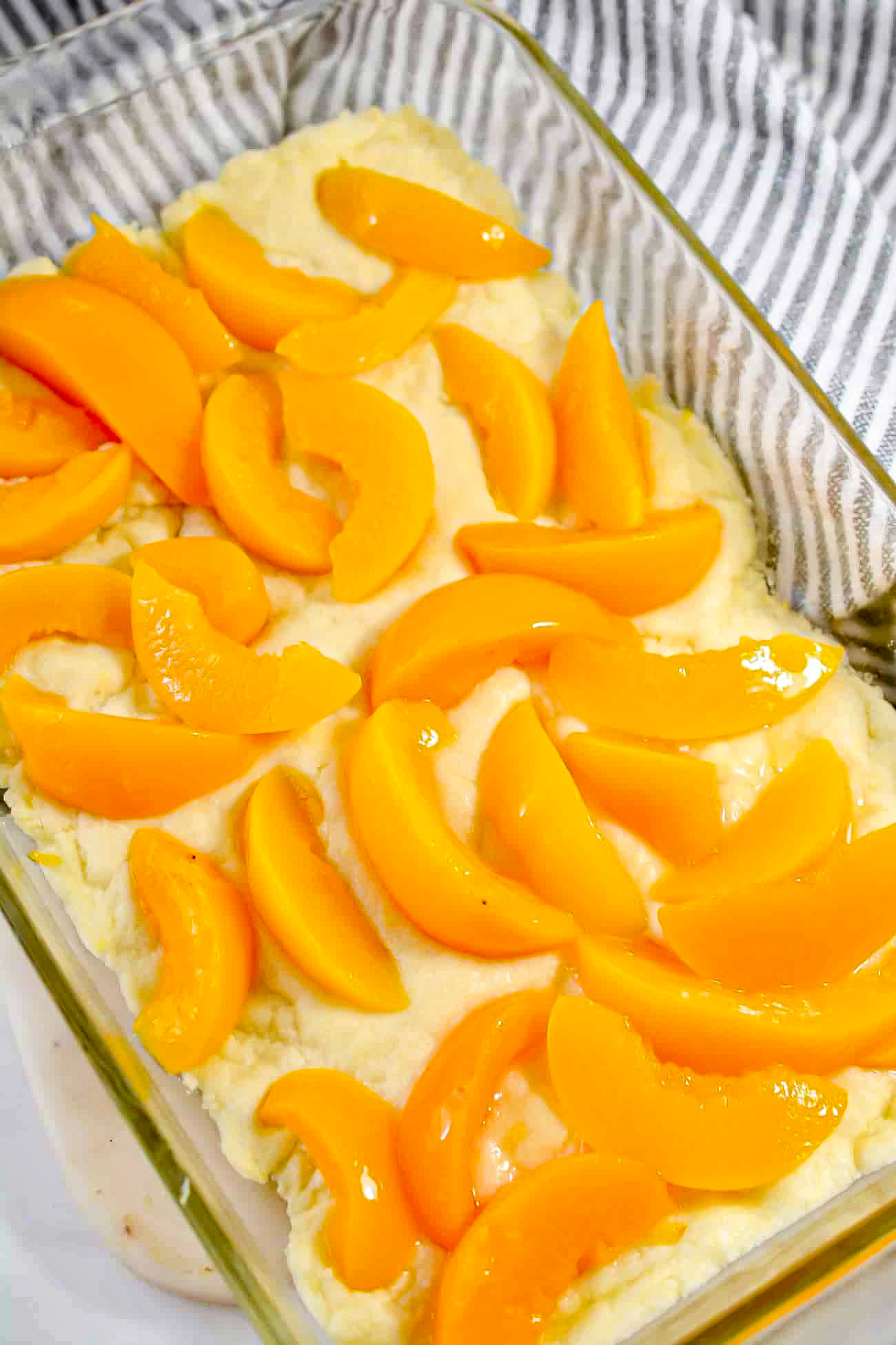 Spread the drained peaches over the pre-baked crust