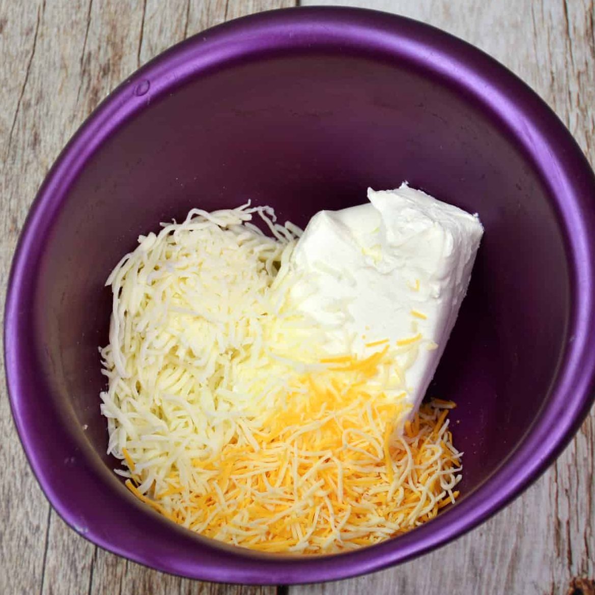 Using a large bowl, mix together the cream cheese, colby jack cheese, and mozzarella until combined.