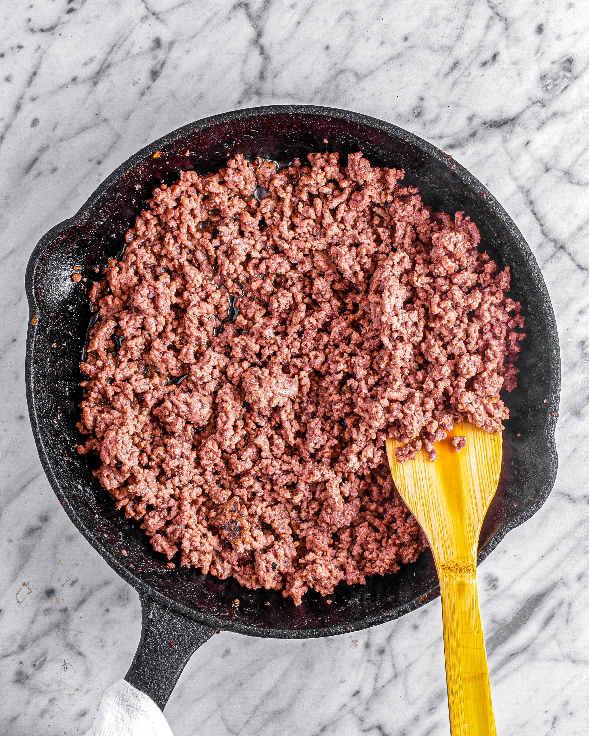 Brown the ground beef in a skillet over medium-high heat, and drain the excess grease. 