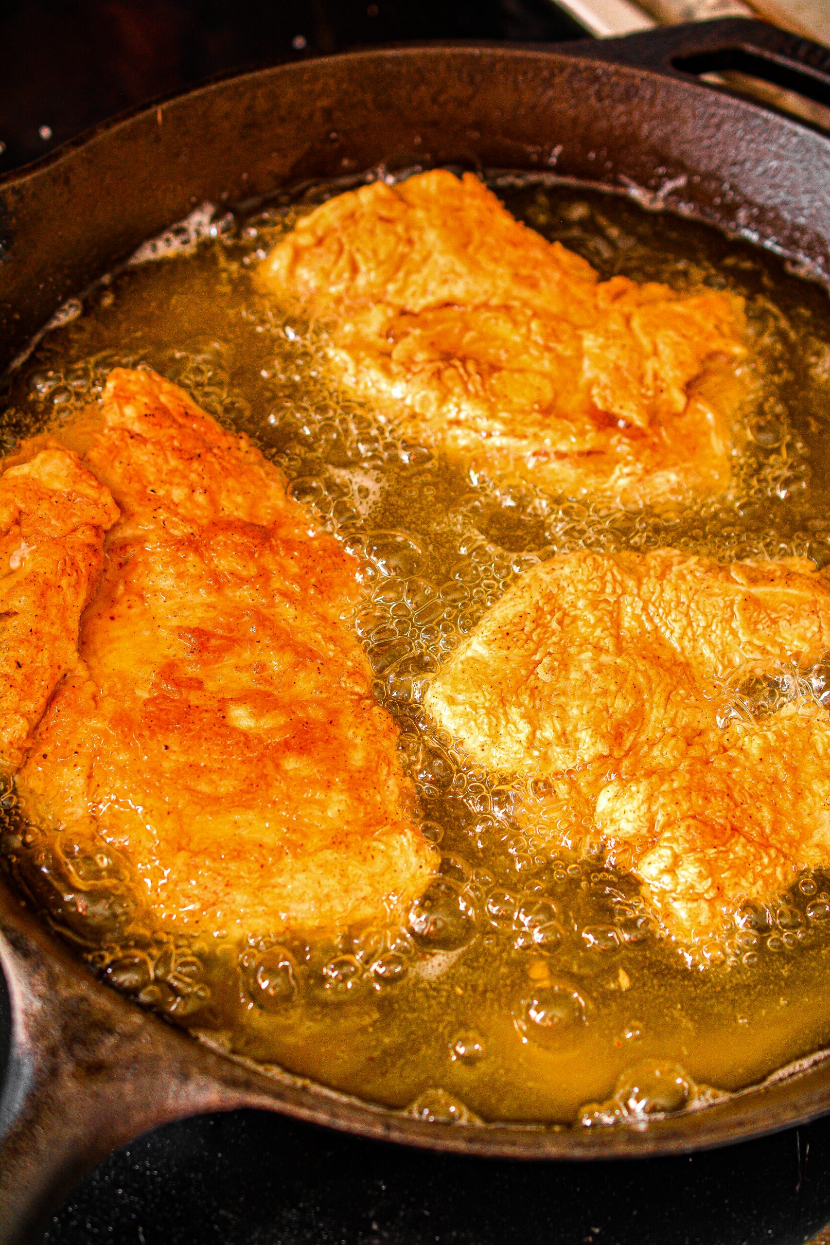 Add the chicken to the heated skillet and fry evenly on both sides until the chicken has reached an internal temperature of at least 165 degrees.