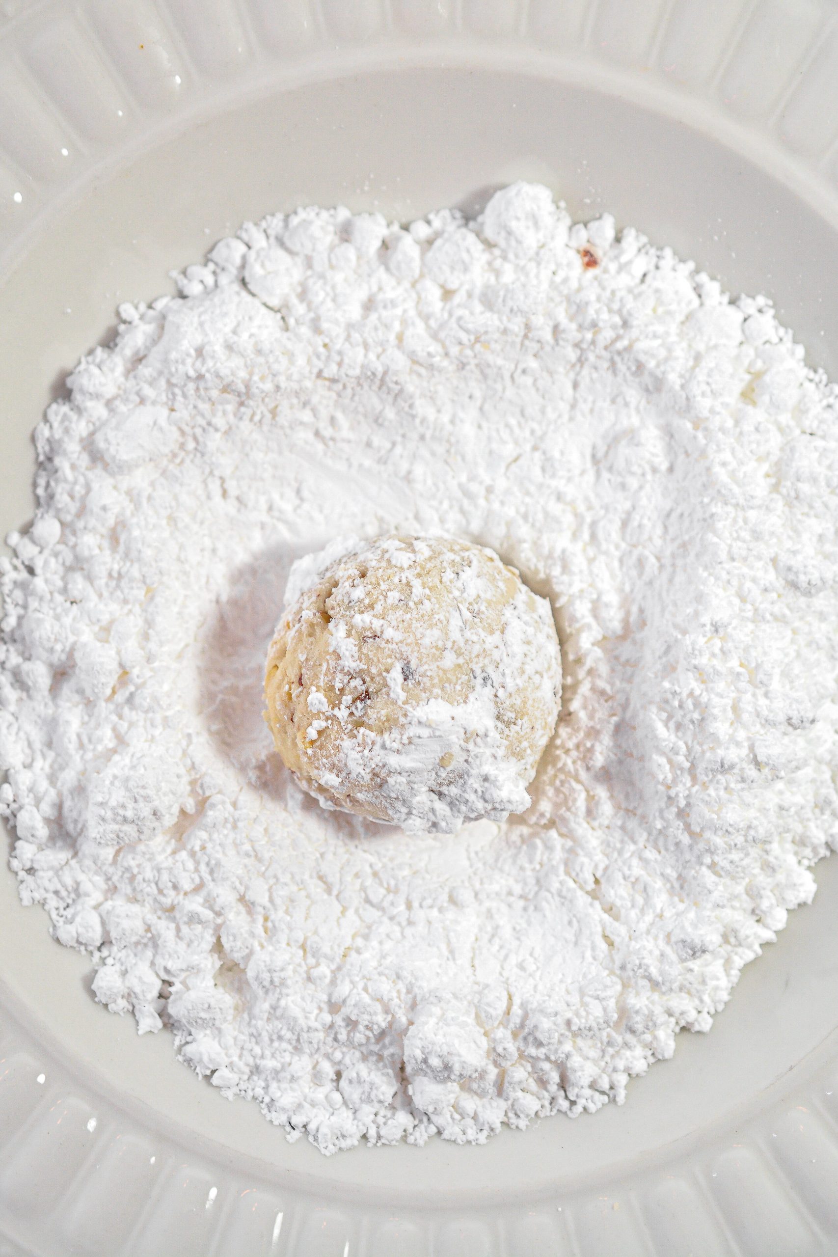 Roll the cookies in the powdered sugar.