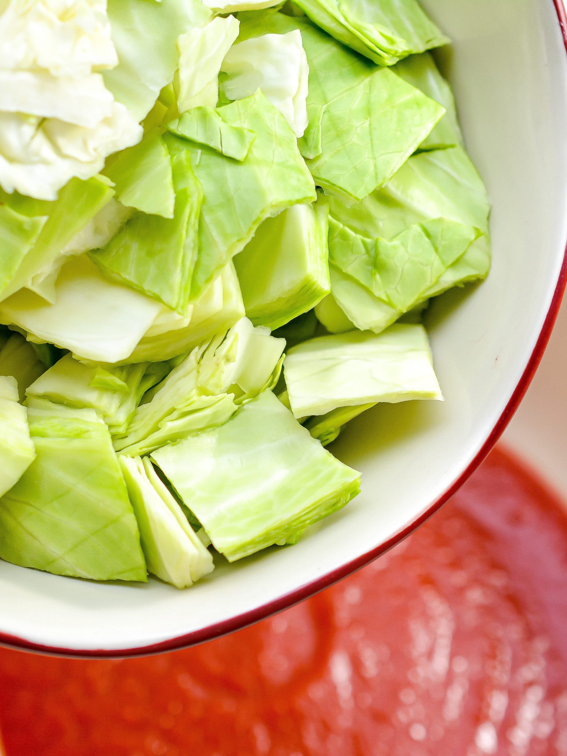 In a large mixing bowl, mix together the cabbage and tomato sauce.