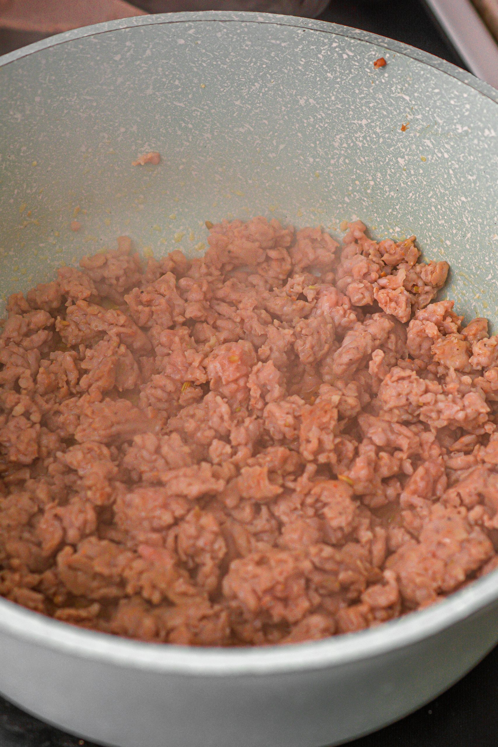 Place the ground beef into a pot, and saute until completely cooked through.
