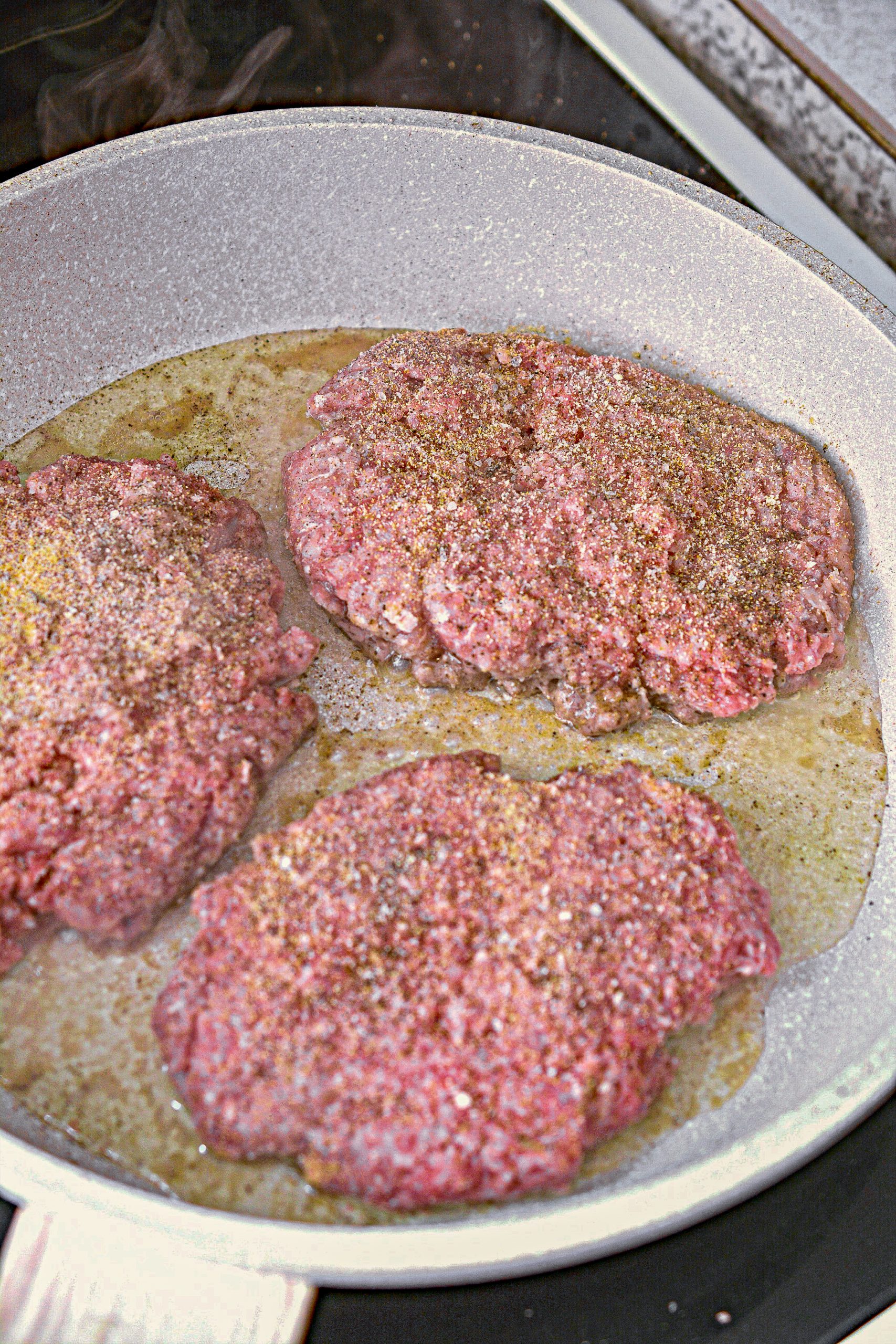 Season the meat on both sides with onion powder, garlic powder, and salt and pepper to taste.