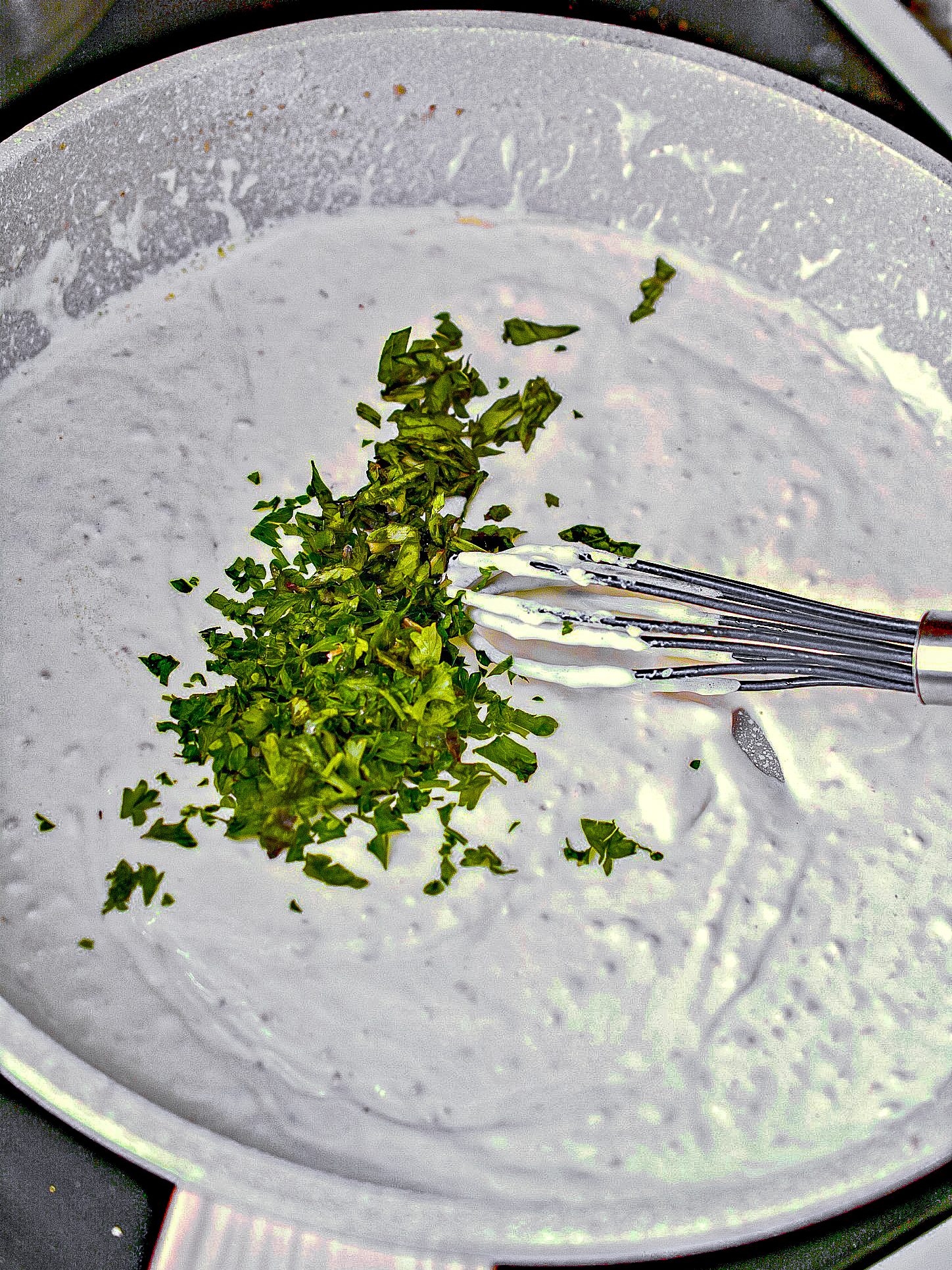 Whisk in the heavy whipping cream, salt, and pepper to taste, basil, and parsley. Cook until the mixture has thickened and is completely combined.