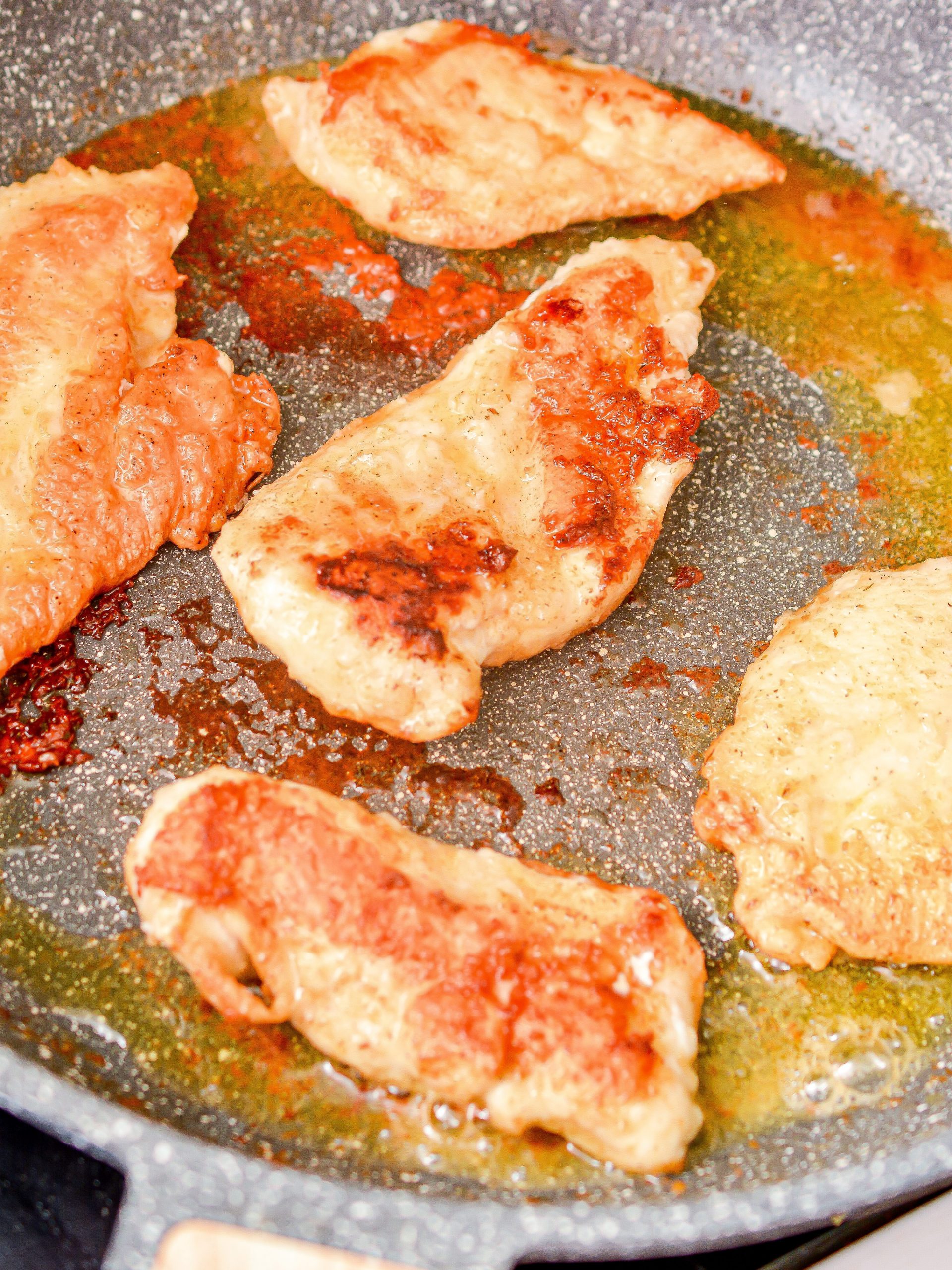 Heat the oil in a large skillet over medium-high heat on the stove and add the chicken. Saute until browned on each side and cooked through. Remove and set aside.