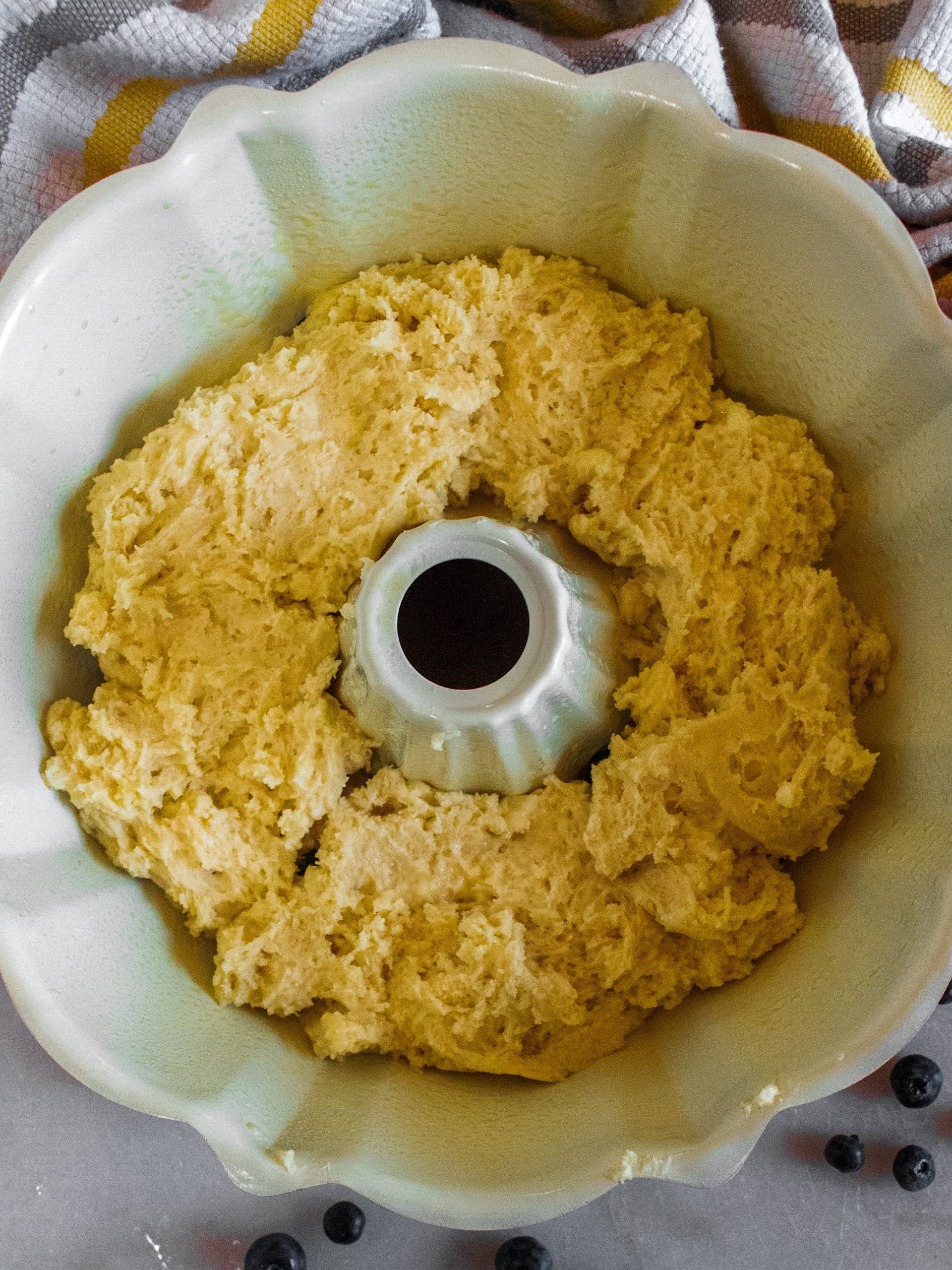 Prepare bundt pan by spraying with non-stick cooking spray. Place half the cake batter in the pan and pat down along the center, making a dent to place the filling into.