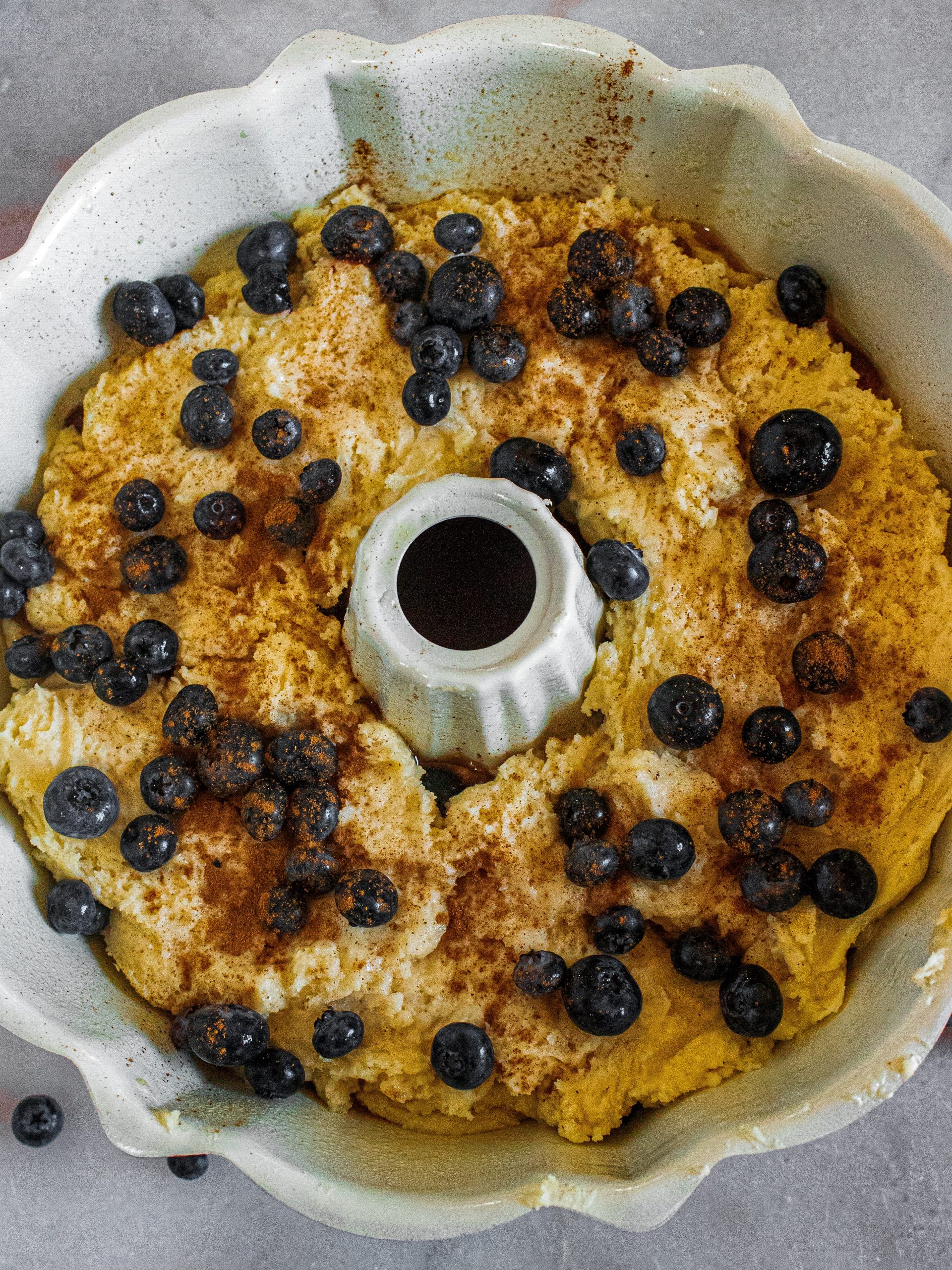 Add the remaining batter to the pan and press down, spreading out evenly over the first layer of batter. Top with the last remaining ½ of blueberries.