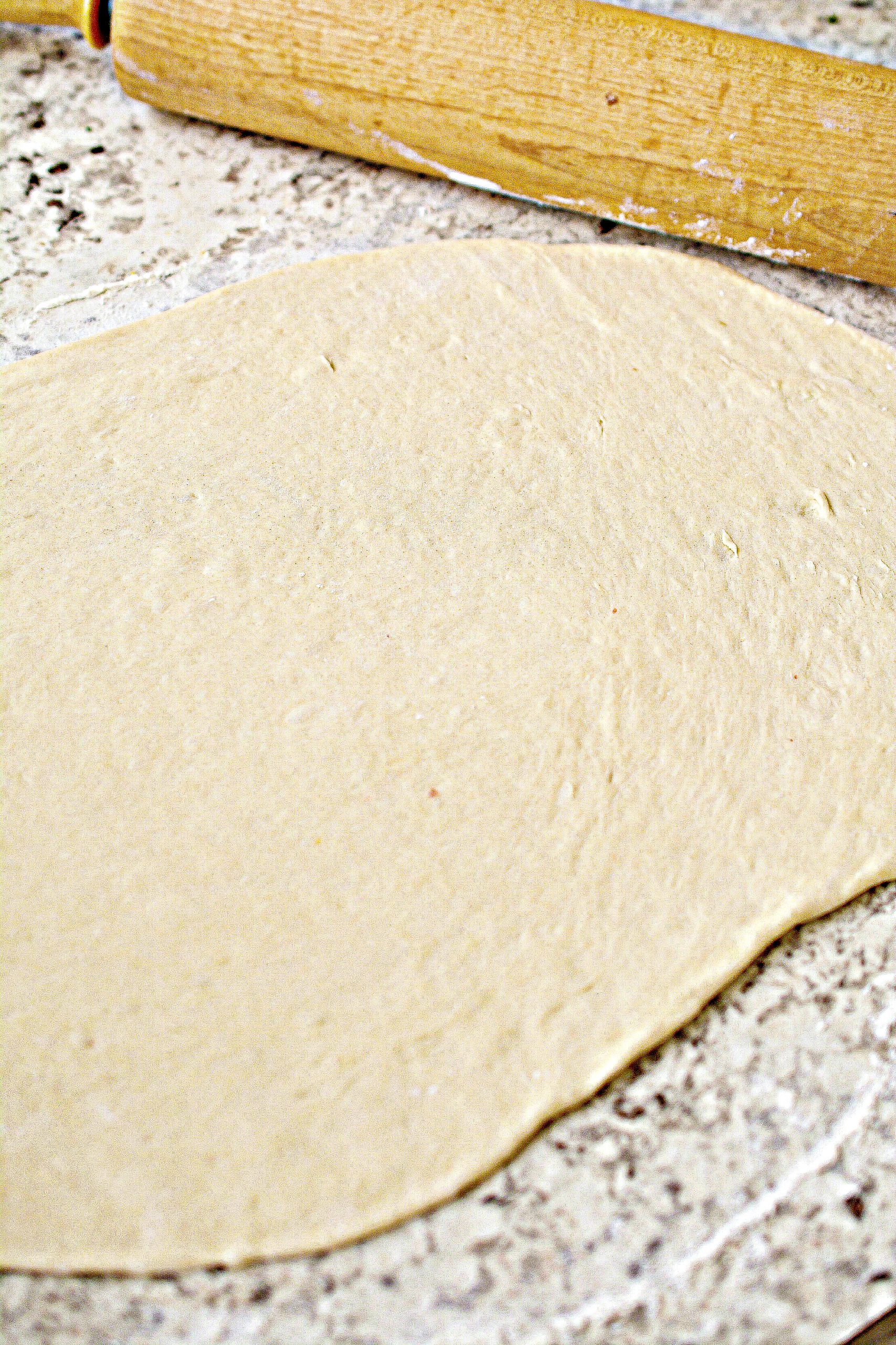 Roll the dough out onto a floured surface into a rectangular shape about ¼ of an inch thick or less.