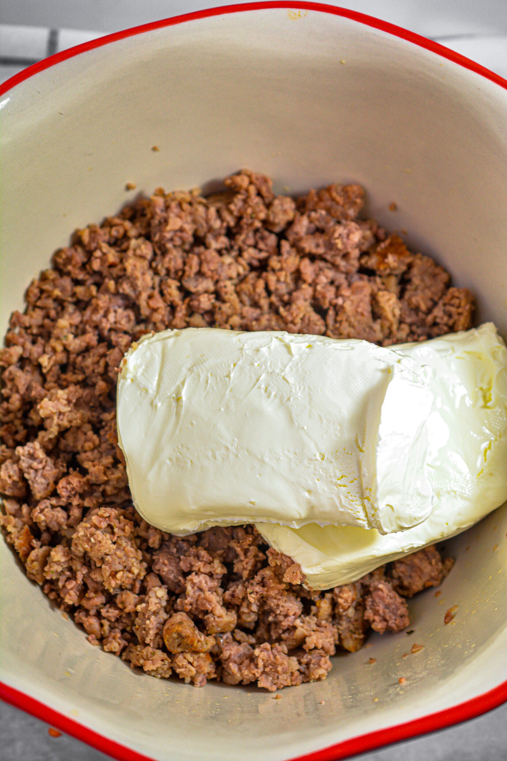 Add the sausage to a bowl, and combine with the cream cheese.