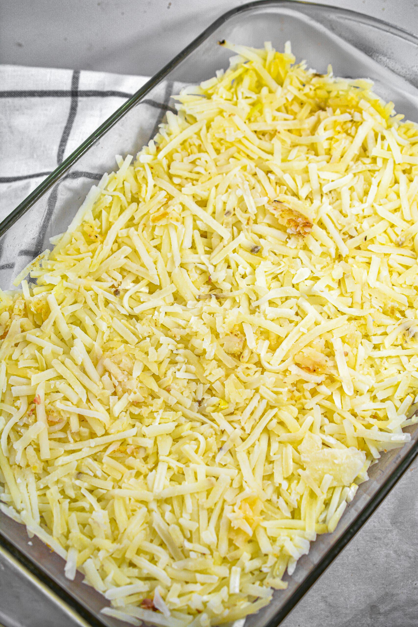 Layer the hashbrowns in the bottom of a well-greased 9x13 baking dish.