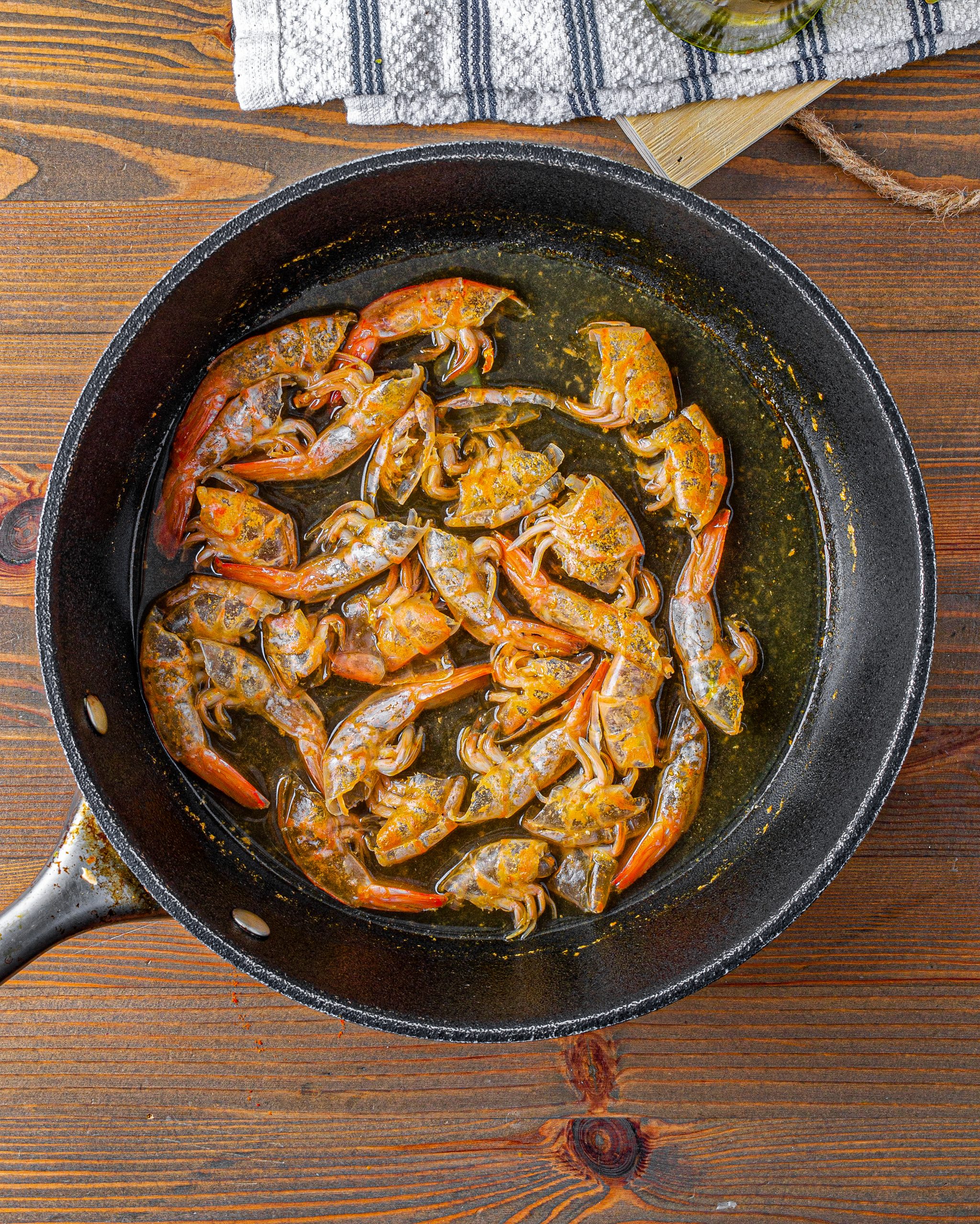Place the shells from the shrimp into a pot of boiling water. Simmer the shells for 20 minutes, then remove them from the pot. 