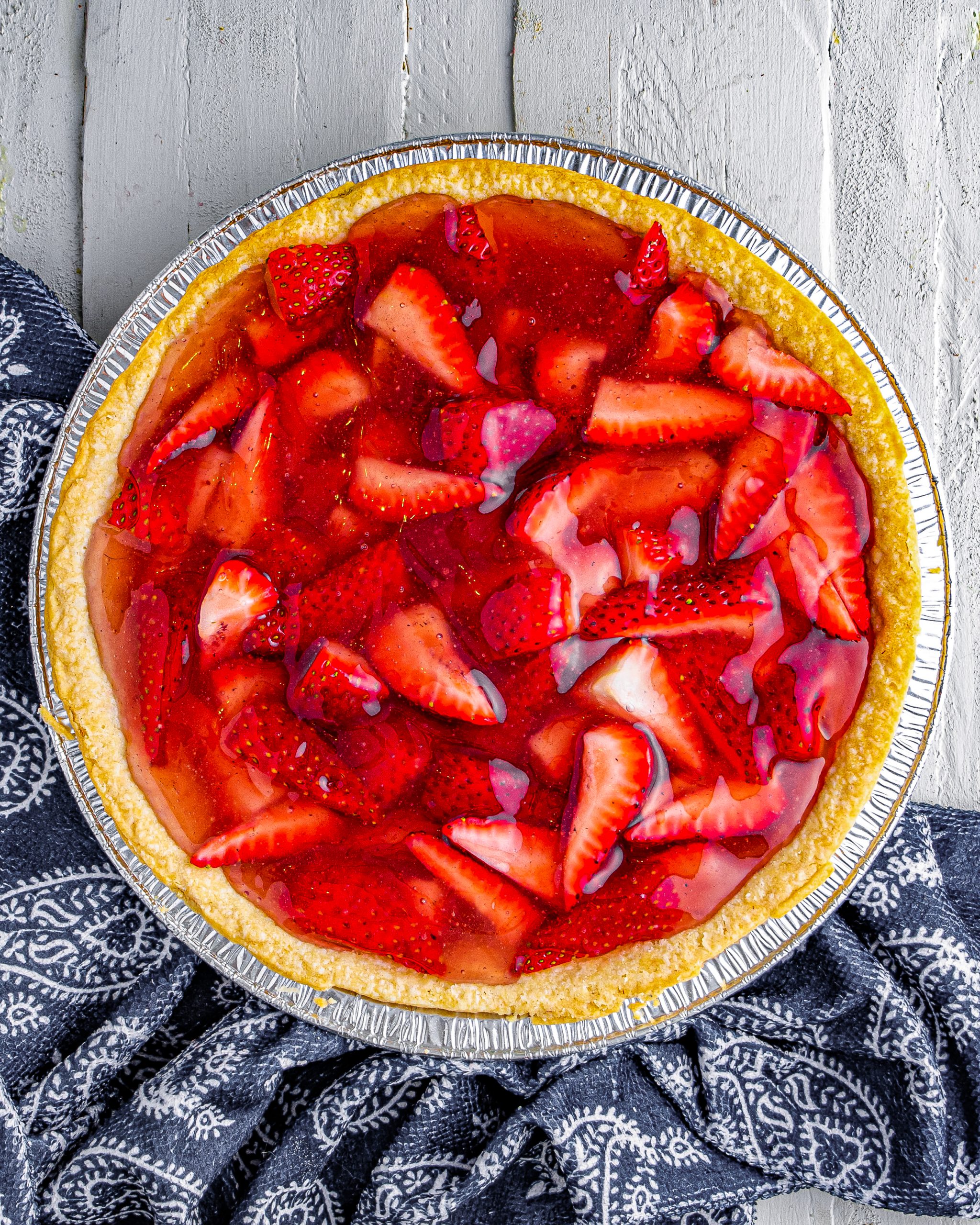 Add strawberries to the cooled pie crust, then pour over the strawberry jelly mixture.