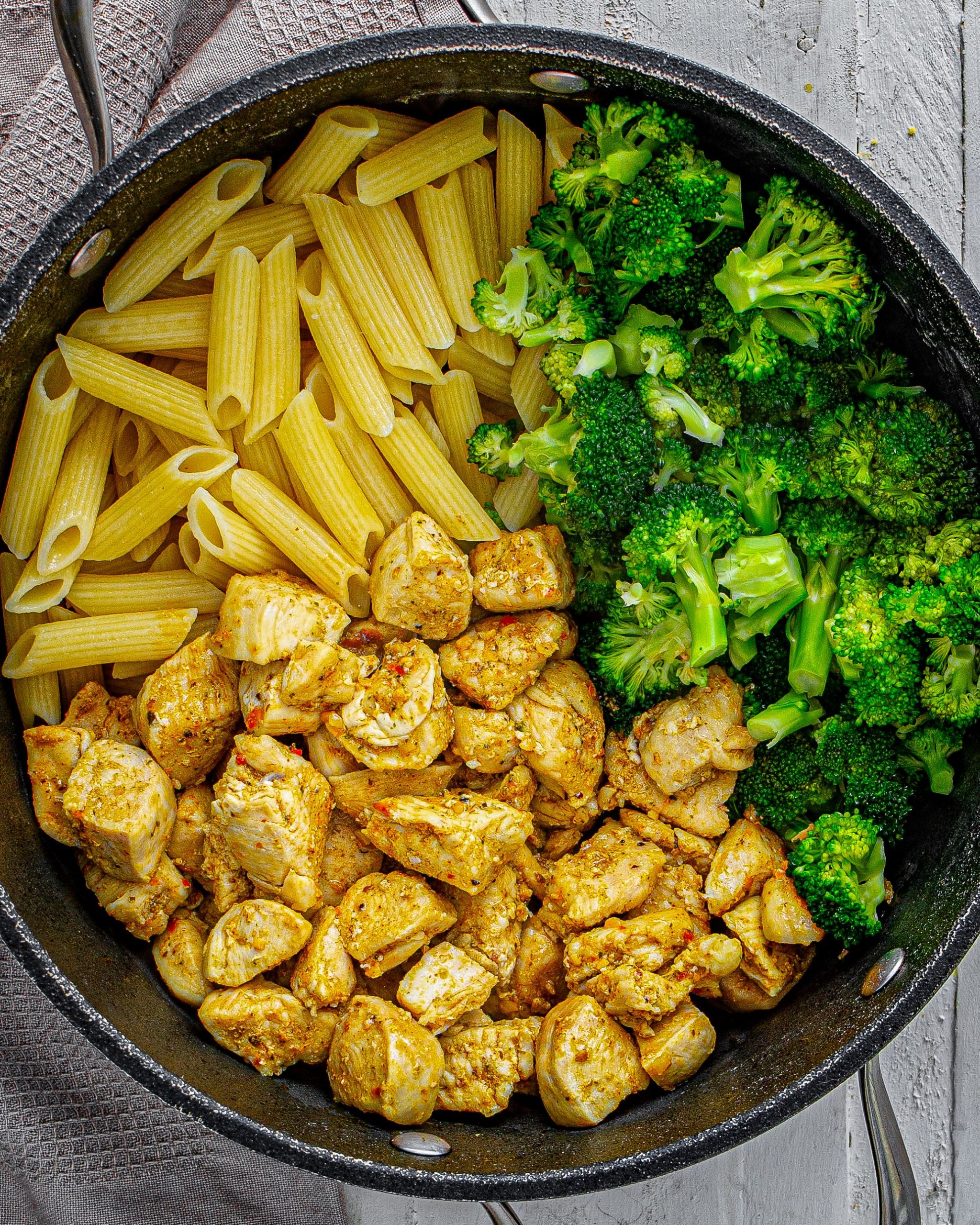 Add the cooked pasta, broccoli, and chicken to a large pot or bowl.