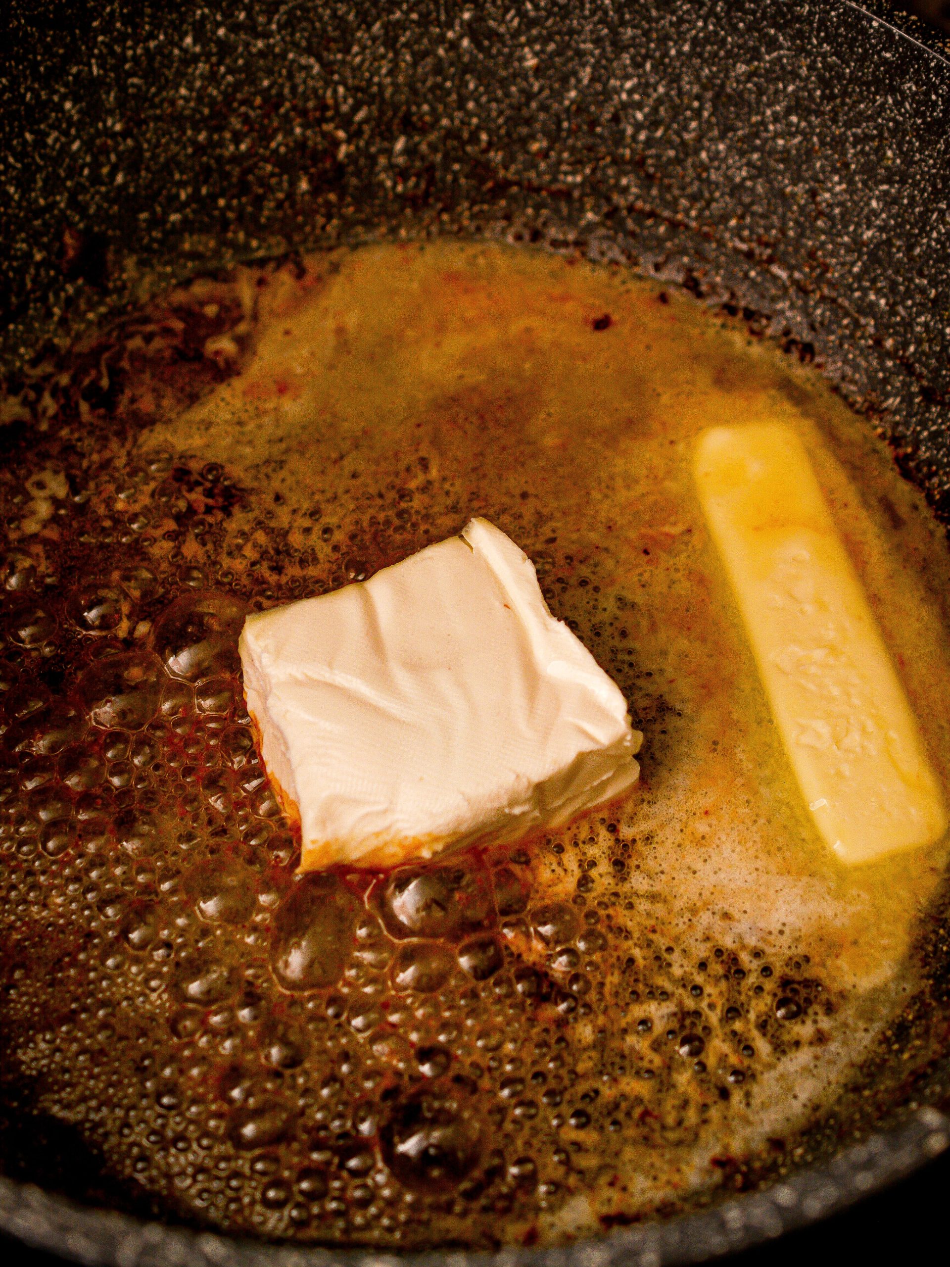 Place the ½ cup butter and 4 oz cream cheese into the skillet.