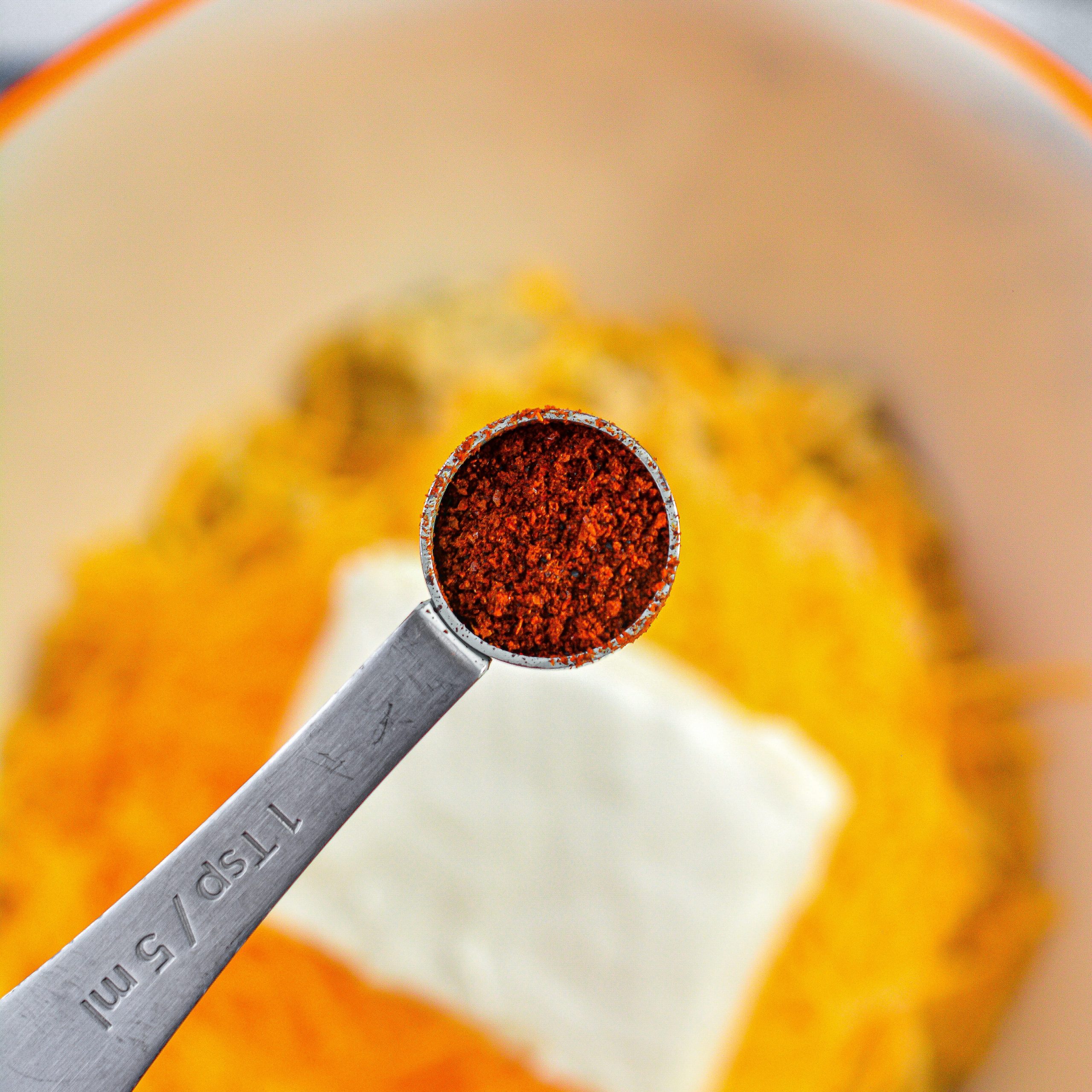 Start adding the seasonings by adding 1 ½ tsp of chili powder.