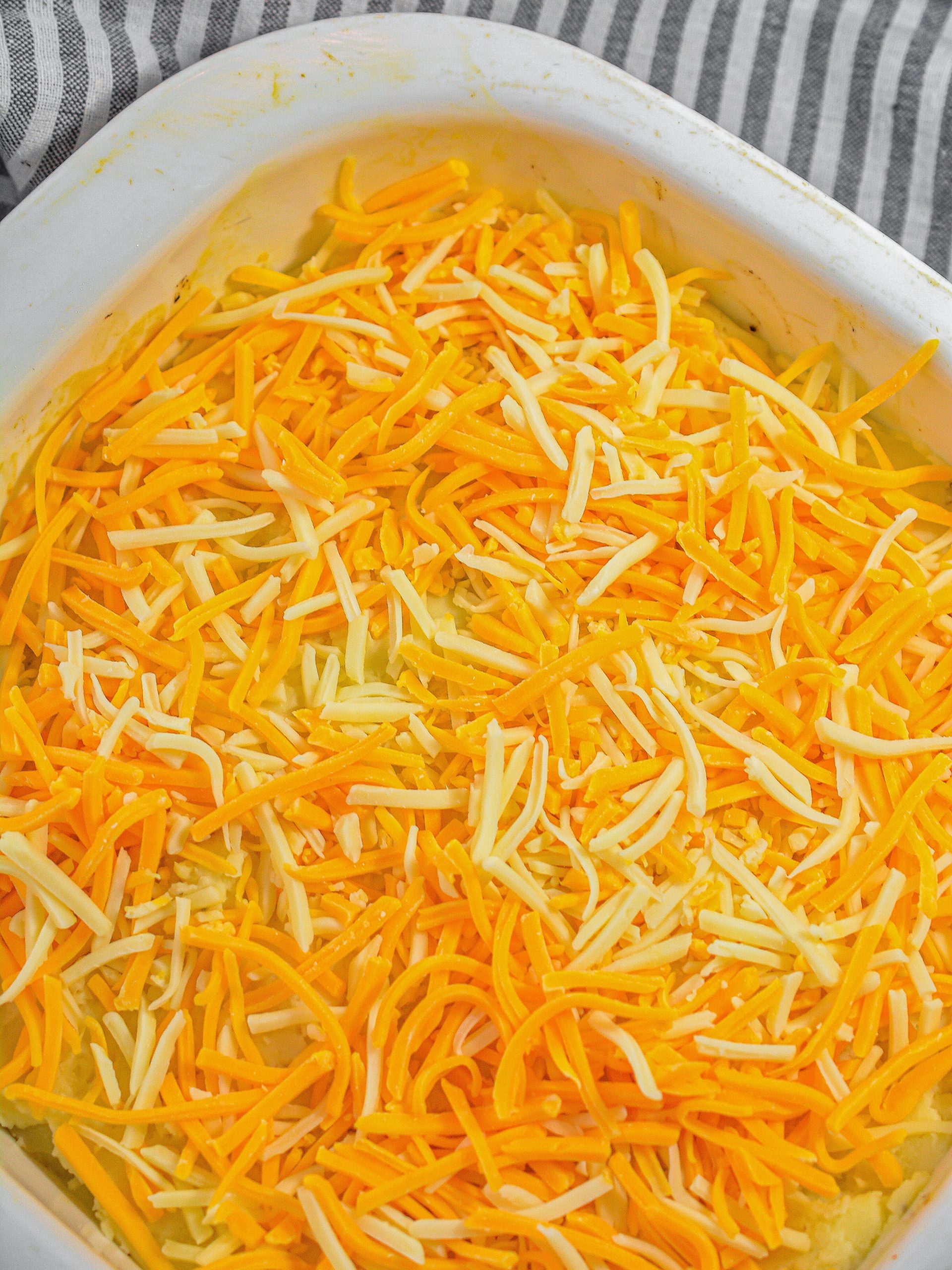 Top the potatoes with the shredded cheese