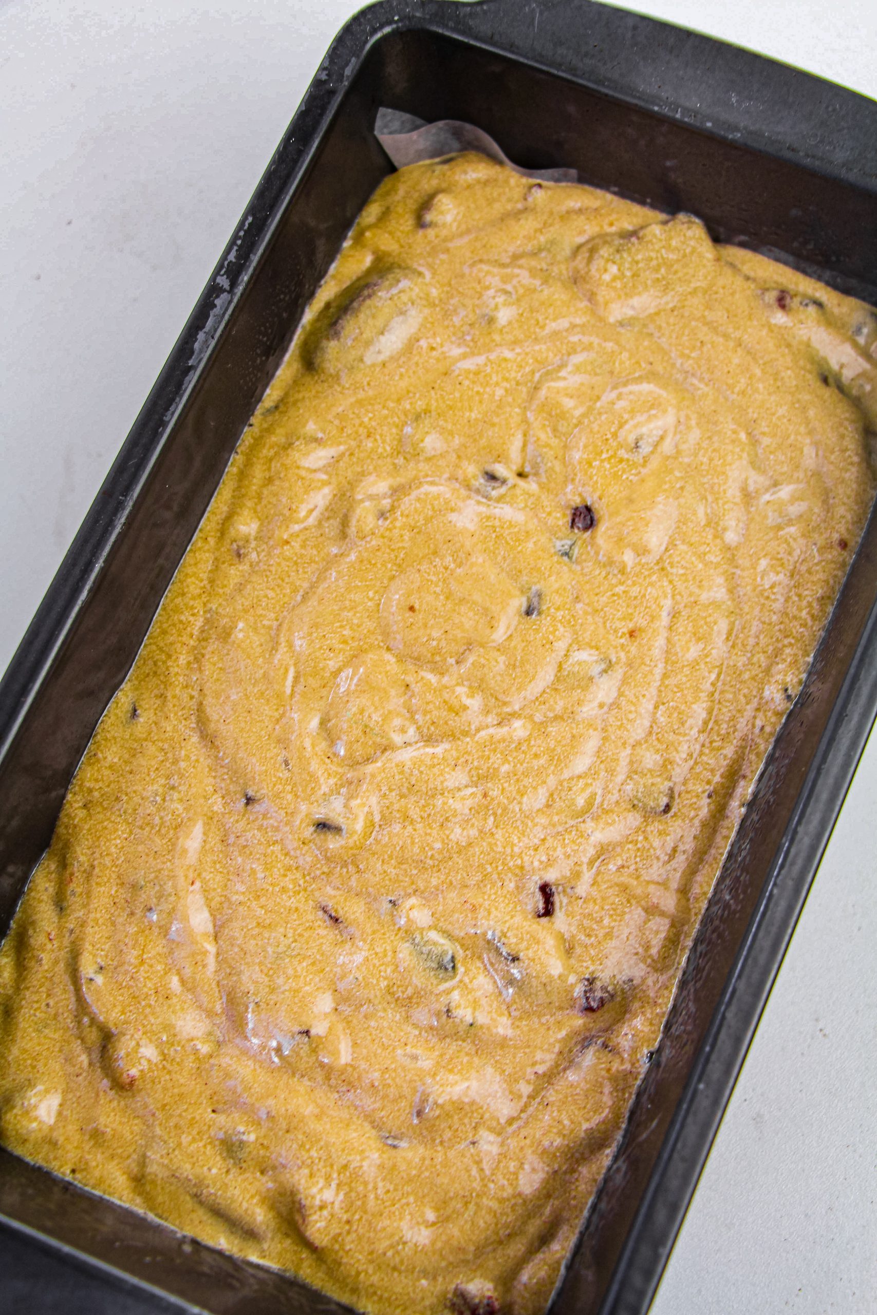 Pour in the fruit cake batter into the loaf pan.